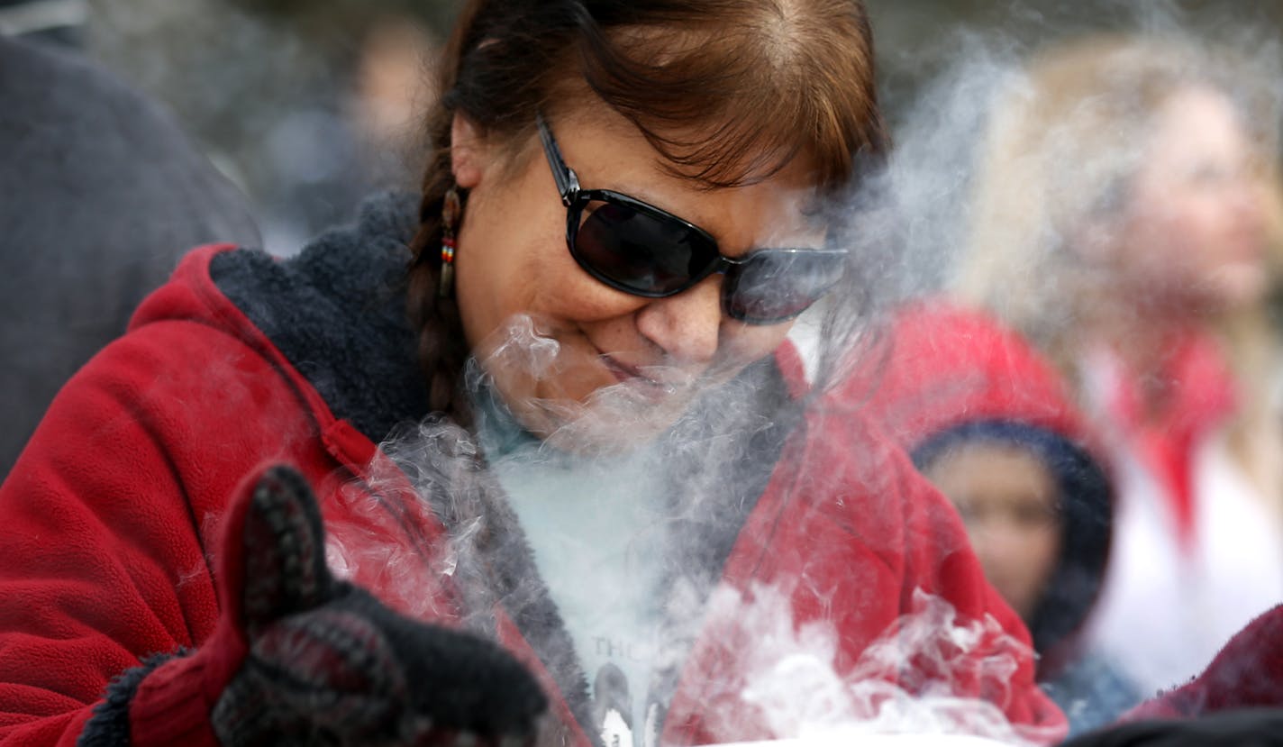 Beth Holcomb of Kasota received sage smoke during the Dakota Wokiksuye Memorial Ride Thursday.