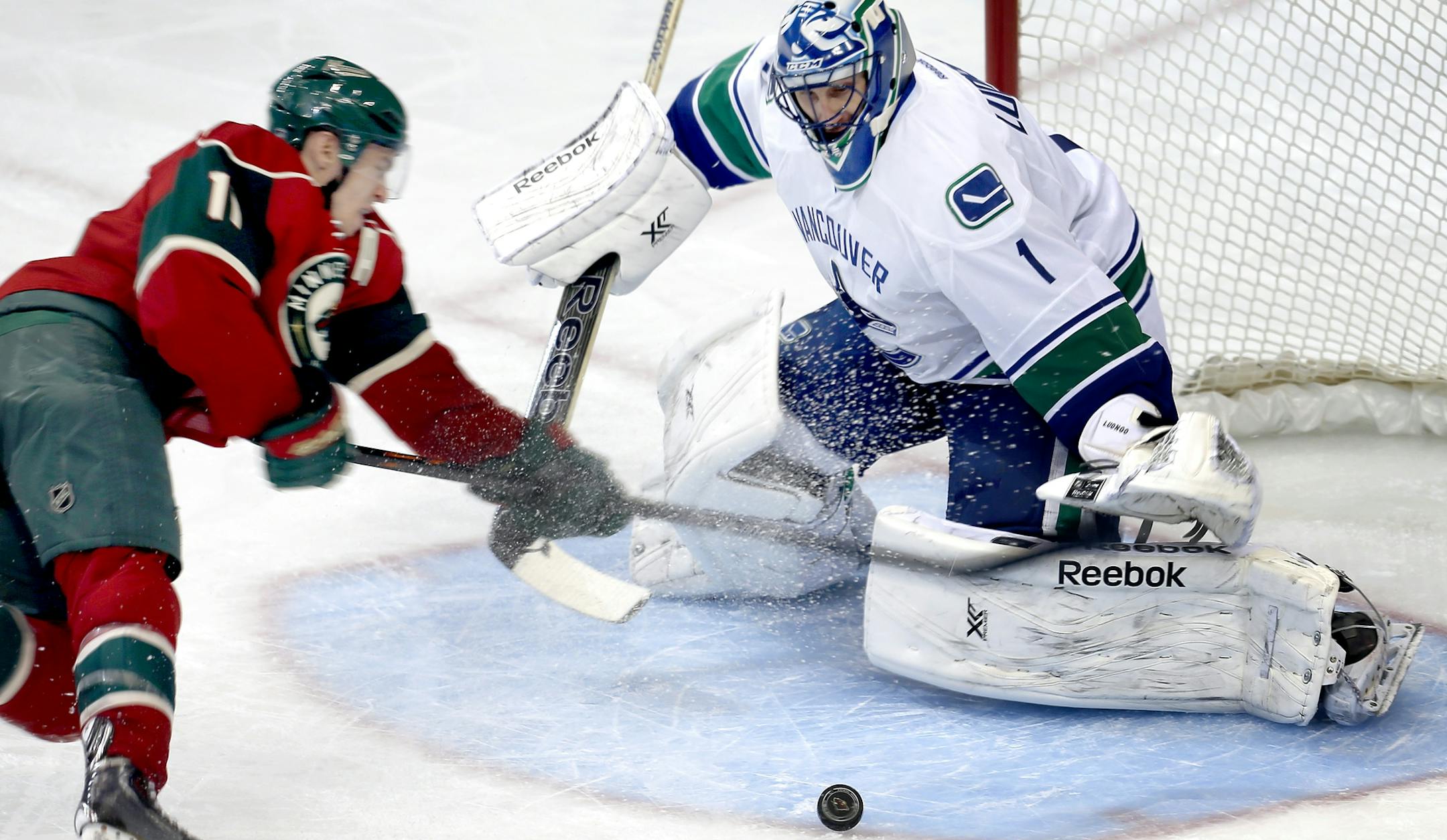 Zach Parise (11) attempted a shot on Vancouver goalie Roberto Luongo (1) in the second period. ] CARLOS GONZALEZ cgonzalez@startribune.com - December 17, 2013, St. Paul, Minn, Xcel Energy Center, NHL, Minnesota Wild vs. Vancouver Canucks ORG XMIT: MIN1312172058471189