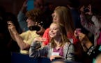 Ellie Meyer waves to Maxwell Meyer, 13, of Minneapolis, on stage during the 2015 Scripps National Spelling Bee, Wednesday, May 27, 2015, at National H