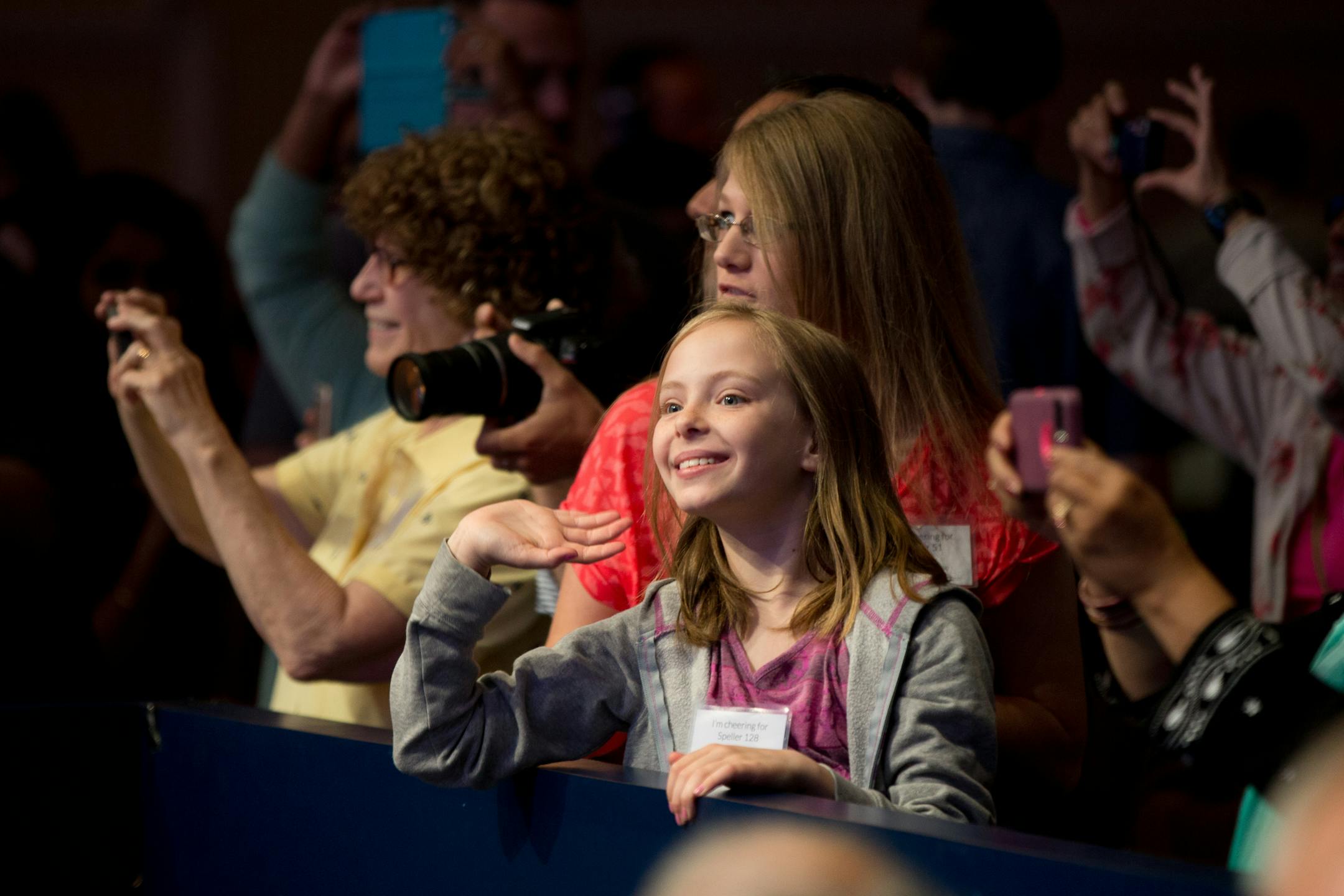 Ellie Meyer waves to Maxwell Meyer, 13, of Minneapolis, on stage during the 2015 Scripps National Spelling Bee, Wednesday, May 27, 2015, at National Harbor in Oxon Hill, Md.