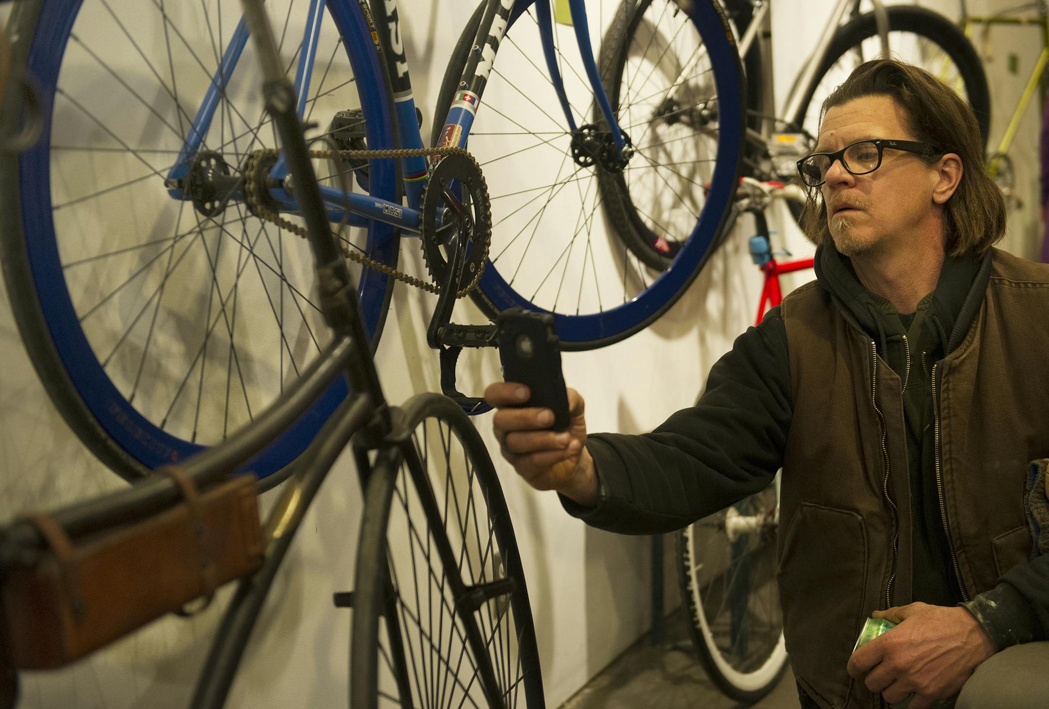 Gary Suber snaps a picture of an early 20th century bicycle on display at the Casket Cinema, Wednesday, March 6th, 2014. ] (Matthew Hintz, 030614, Minneapolis)