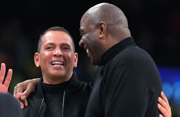 Magic Johnson, right, greets Alex Rodriguez during a game in 2018. Rodriguez and Marc Lore are set to buy the Timberwolves and Lynx.