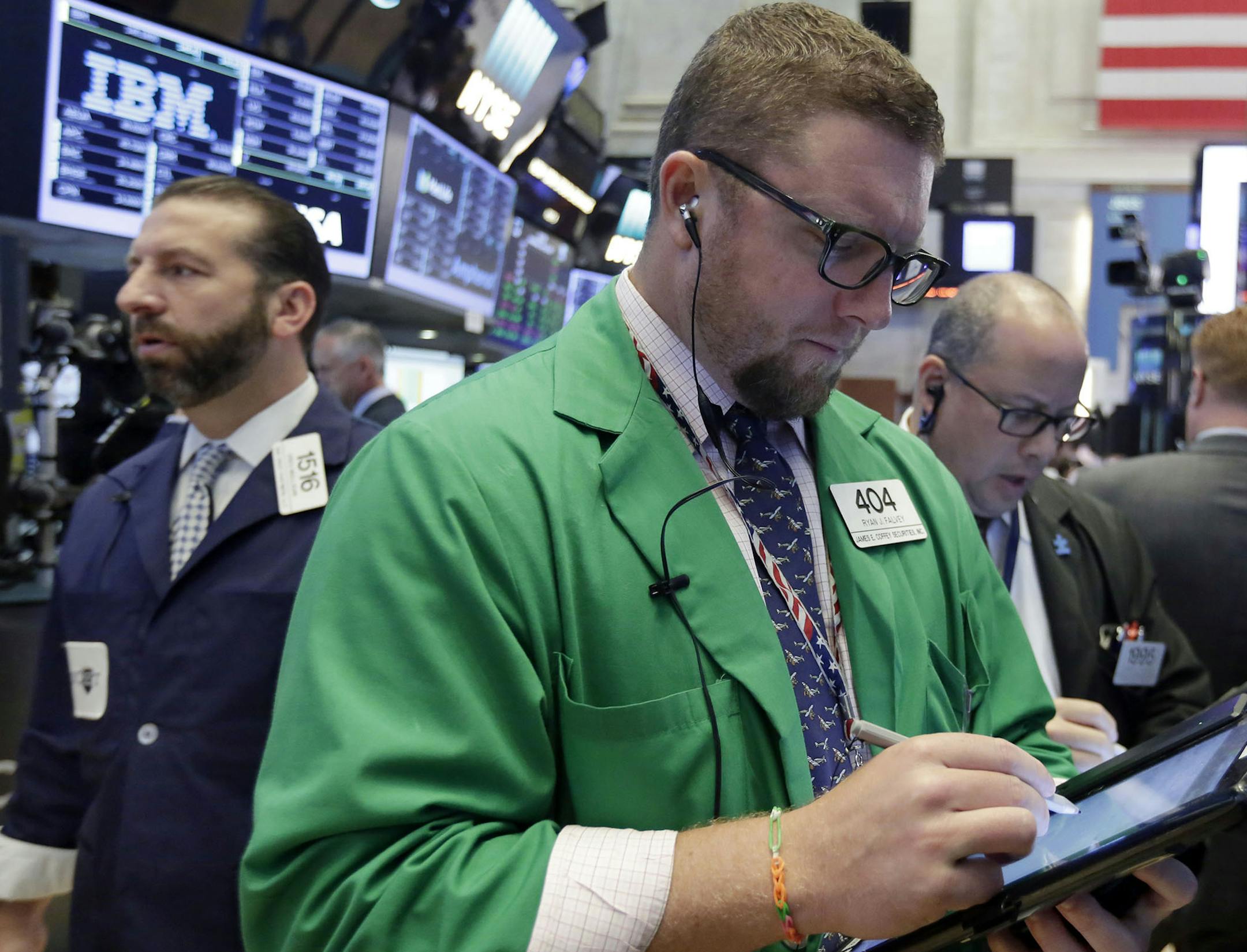 Trader Ryan Falvey, center, works on the floor of the New York Stock Exchange, Wednesday, July 26, 2017. Stocks are opening higher on Wall Street as several big companies including Boeing and AT&T report solid results. (AP Photo/Richard Drew) ORG XMIT: MIN2017072711245710