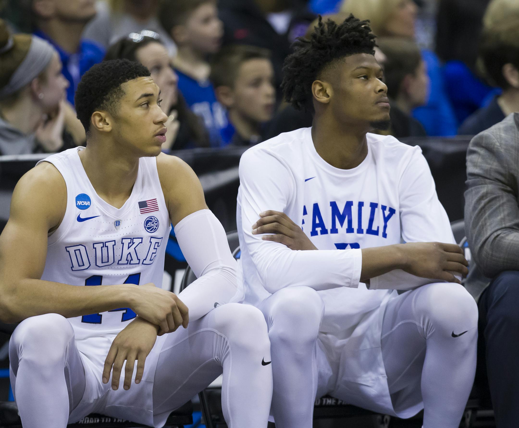 Duke forward Cam Reddish, center, sits on the bench during the team's East Regional semifinal against Virginia Tech in the NCAA men's college basketball tournament in Washington on Friday, March 29, 2019. Reddish will be a game-time decision for Duke's Elite Eight NCAA Tournament game Sunday against Michigan State because of a knee injury. (AP Photo/Alex Brandon)