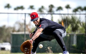 Jose Miranda scoops a ball during a February practice at Hammond Stadium in Fort Myers, Fla.