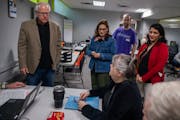 Gov. Tim Walz greets tax preparation volunteers at the nonprofit Prepare and Prosper in St. Paul on Monday.