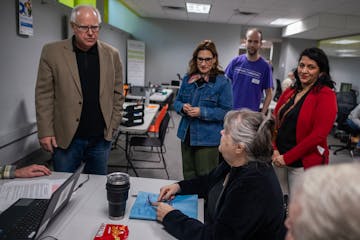 Gov. Tim Walz greets tax preparation volunteers at the nonprofit Prepare and Prosper in St. Paul on Monday.