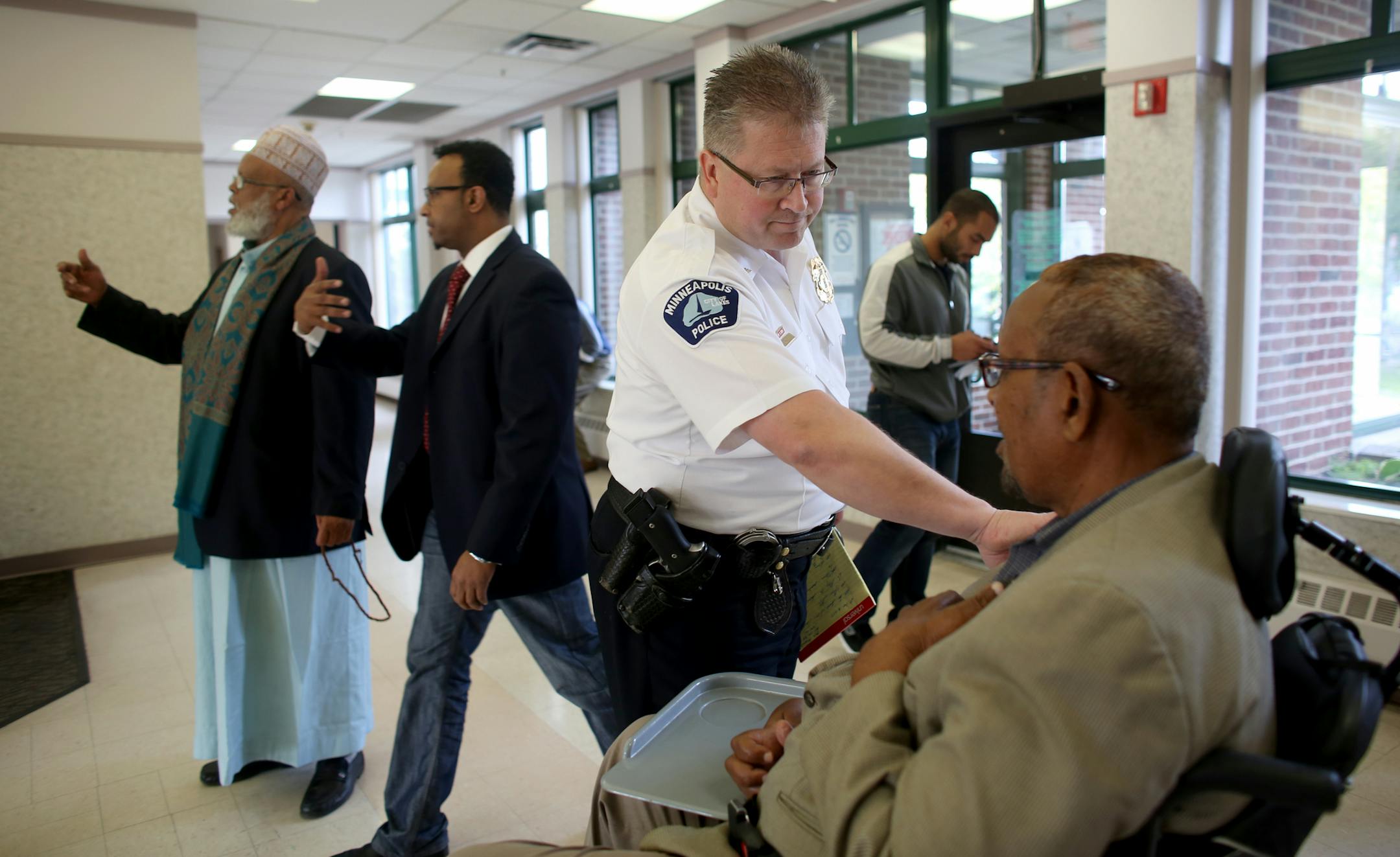 Minneapolis Inspector Todd Loining, of the Fifth Precinct, talked at Horn Towers with Mohamed Hassan about how sorry he was for the loss of Abdi Haji Mohamed Liiban.