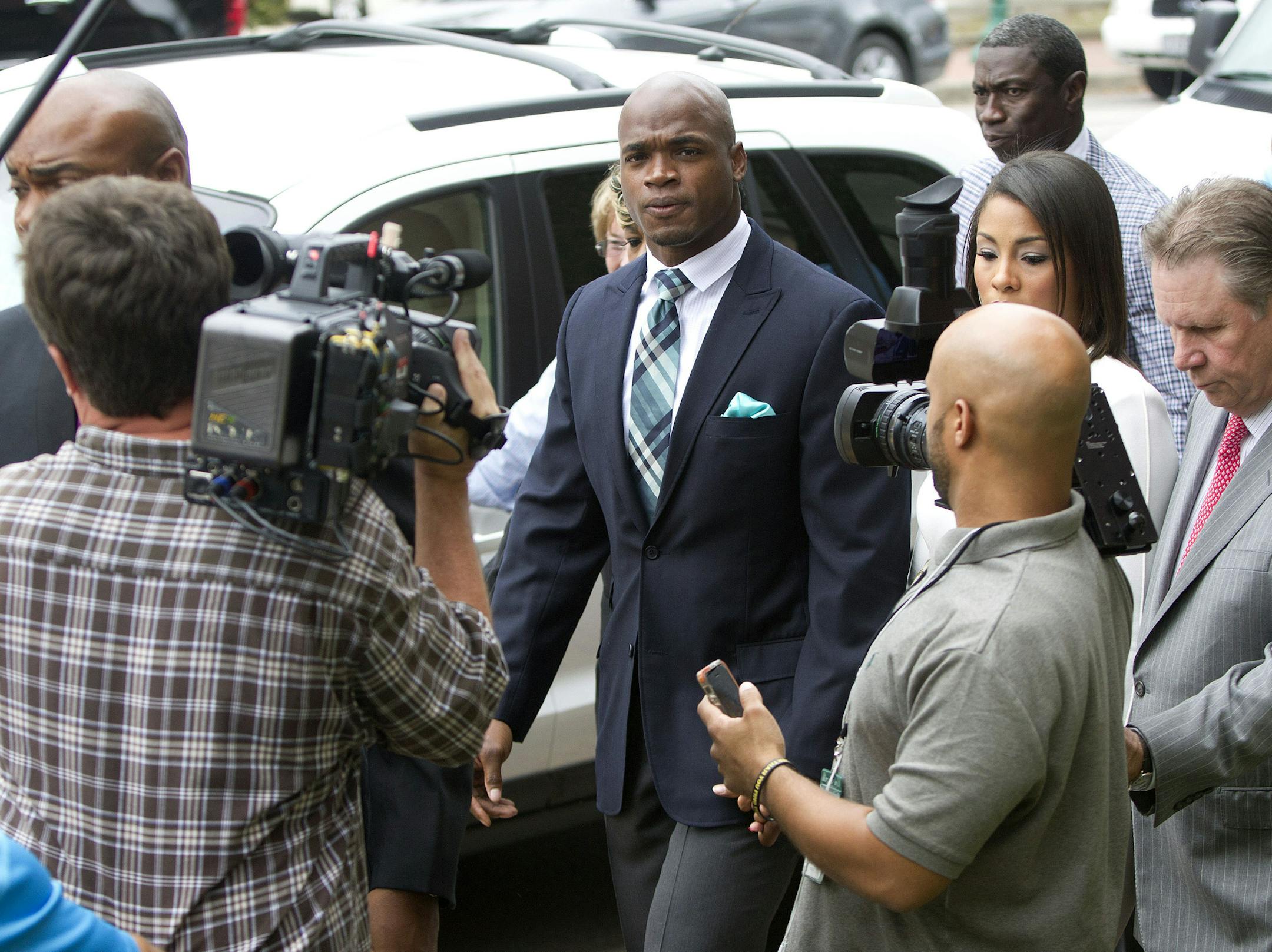 Minnesota Vikings running back Adrian Peterson arrives at the courthouse with his wife Ashley Brown Peterson, for an appearance Tuesday, Nov. 4, 2014, in Conroe, Texas. Minnesota Vikings star Adrian Peterson avoided jail time on Tuesday in a plea agreement reached with prosecutors to resolve his child abuse case. (AP Photo/ The Courier, Jason Fochtman)