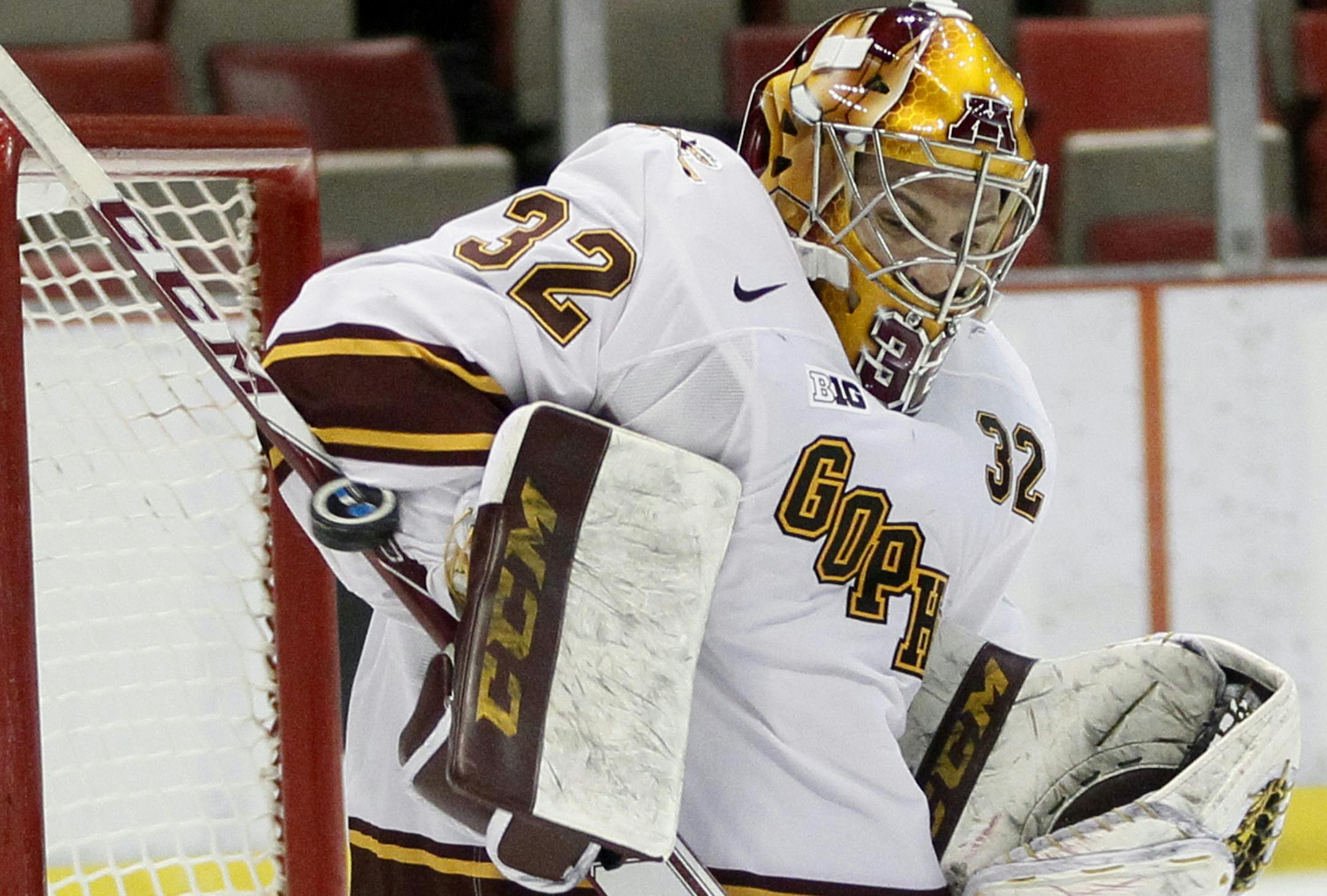 Minnesota goalie Adam Wilcox (32) makes one of his 39 saves against Ohio State during the second period of an NCAA college hockey game in the Big Ten Conference tournament Friday, March 20, 2015, in Detroit. Minnesota defeated Ohio State 3-0. (AP Photo/Duane Burleson) ORG XMIT: MIN2015032020433813