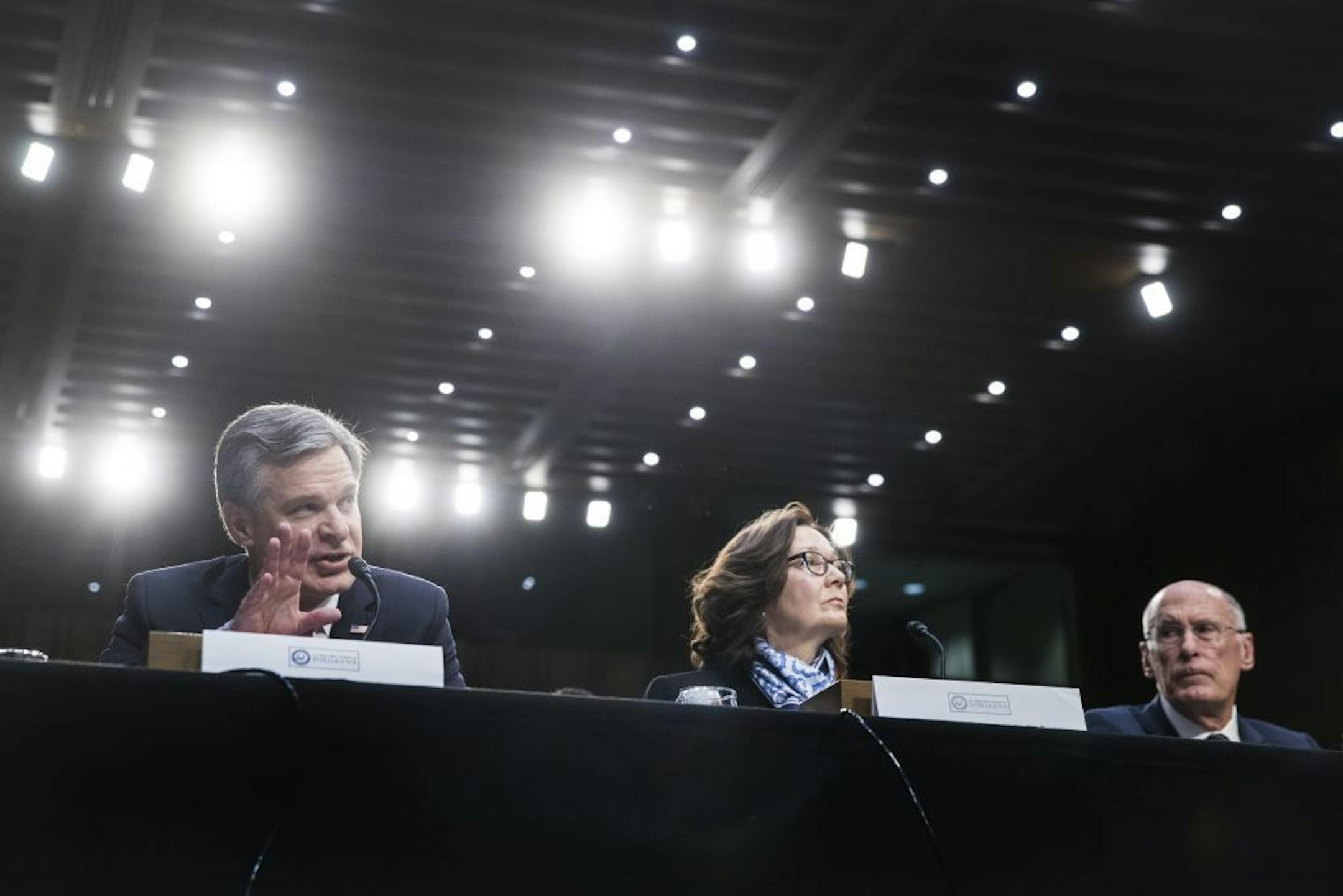 From left: FBI Director Christopher Wray, CIA Director Gina Haspel and National Intelligence Director Dan Coats testify at a hearing with the Senate Intelligence Committee on Capitol Hill, in Washington, Jan. 29, 2019. North Korea is "unlikely to give up" its nuclear stockpiles and Iran is not trying to develop nuclear weapons, a new intelligence assessment says, directly challenging the president's assertions.
