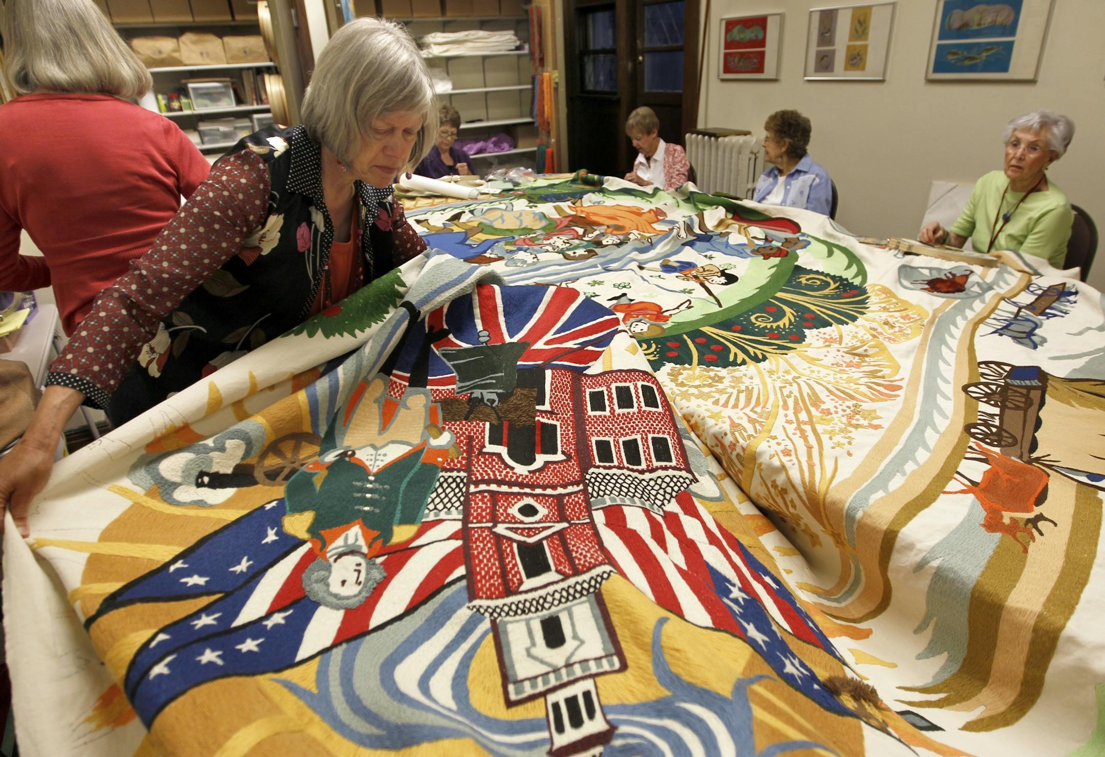 "Needlers" at Plymouth Congregational Church have been stitching a huge First Amendment themed tapestry for over 10 years .Sixteen feet tall by 25 feet wide, it is the last of four seasonal-themed embroidered wall hangings they have done for the reception hall. "Summer of the First Amendment" celebrates the theme of separation of church and state. Barb Souther, foreground, displayed a section of the embroidery.