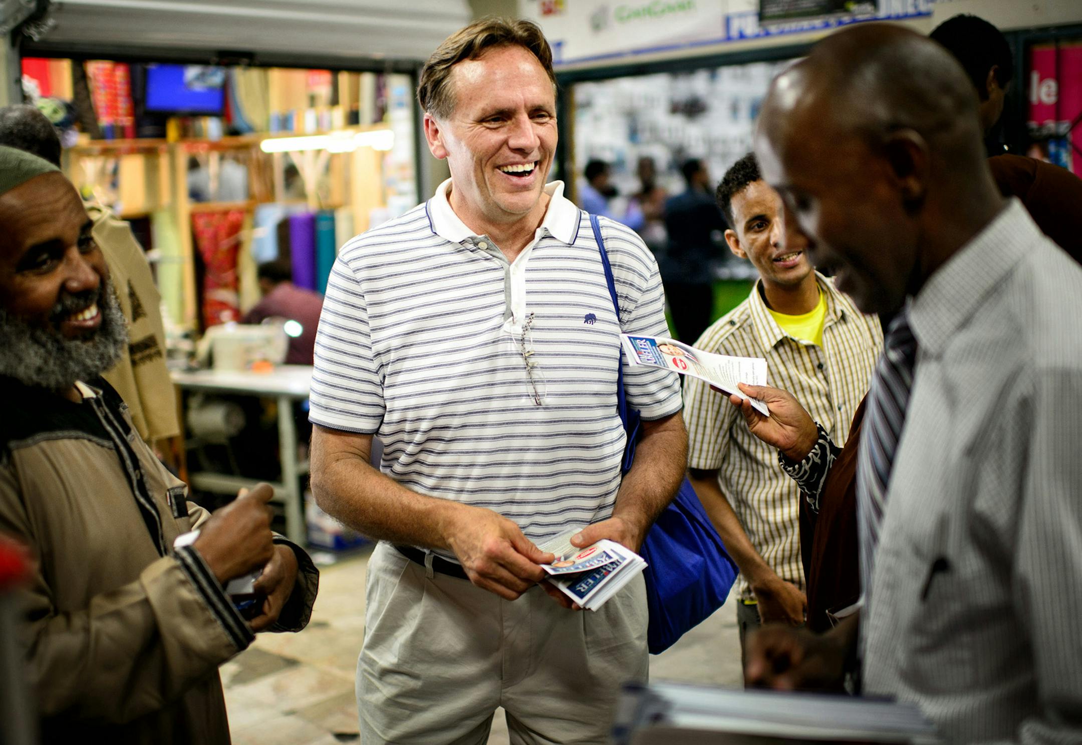 State Rep. Jim Abeler asked Somalis for their vote in the August 12 primary in his race against Mike McFadden to go up against Sen. Al Franken for the U.S. Senate seat. He handed out brochures in both English and Somali Friday after prayers at Somali Village Market in Minneapolis. ] Friday, August 1, 2014. GLEN STUBBE * gstubbe@startribune.com ORG XMIT: MIN1408011641271205 ORG XMIT: MIN1408011735261244