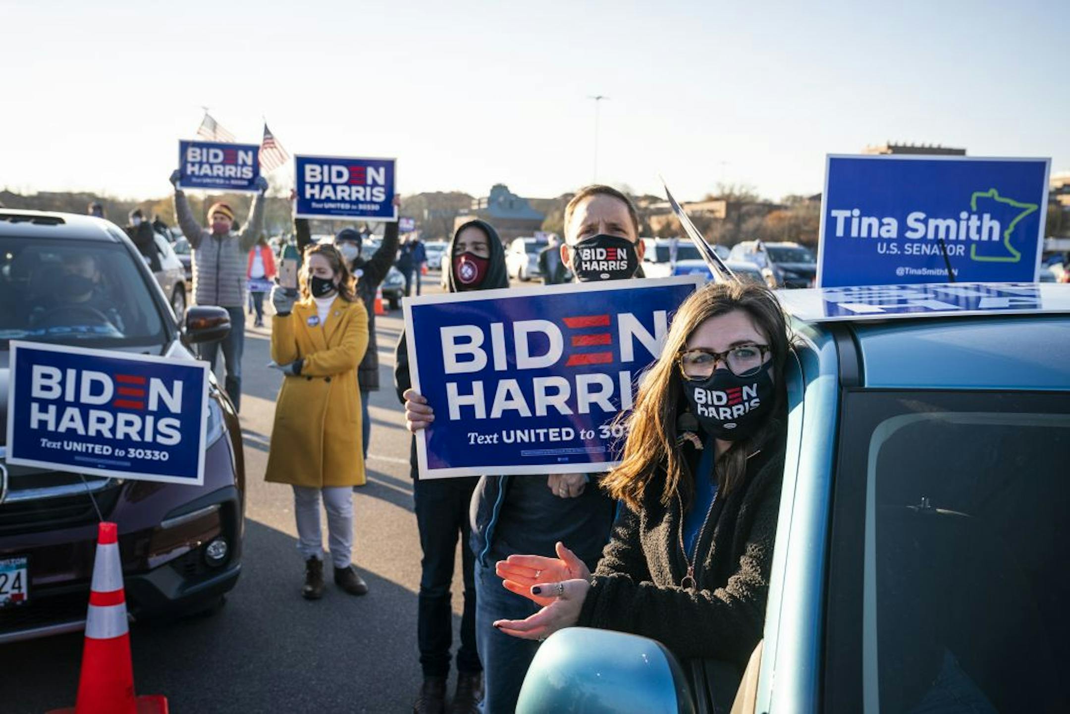 Emma Burns and Trevor Burns of St. Paul listened as former Vice President Joe Biden spoke during a drive-in campaign event in Falcon Heights.
