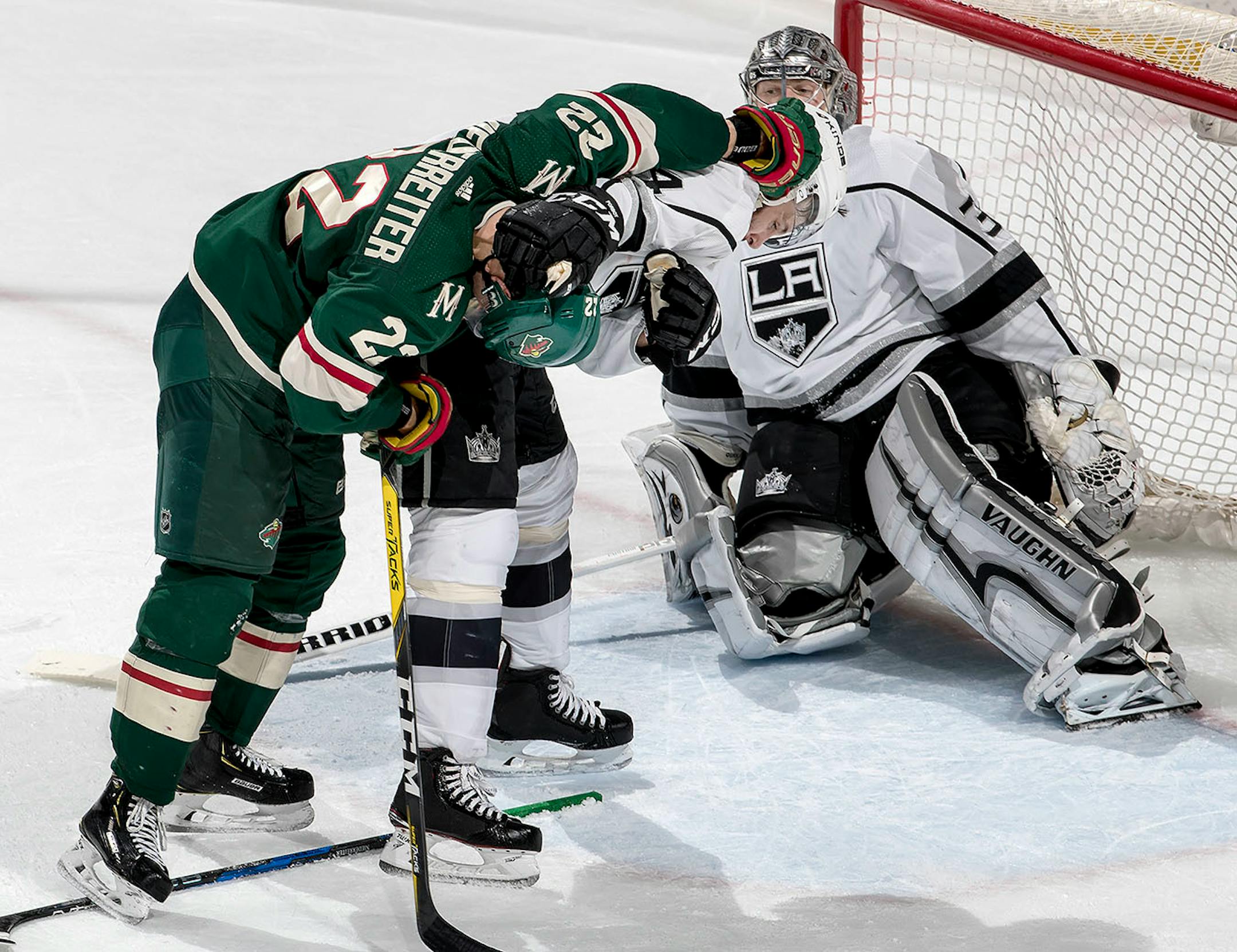 Nino Niederreiter (22) and Derek Forbort (24) got into a scuffle in the second period.