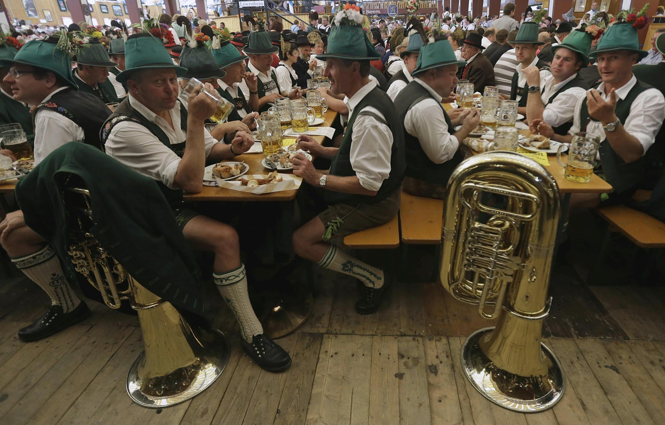 Participants of the Oktoberfest folklore parade eat and drink in a beer tent at the famous Bavarian "Oktoberfest" beer festival in Munich, southern Germany, Sunday, Sept. 23, 2012. The world's largest beer festival, to be held from Sept. 22 to Oct. 7, 2012 will see some million visitors.