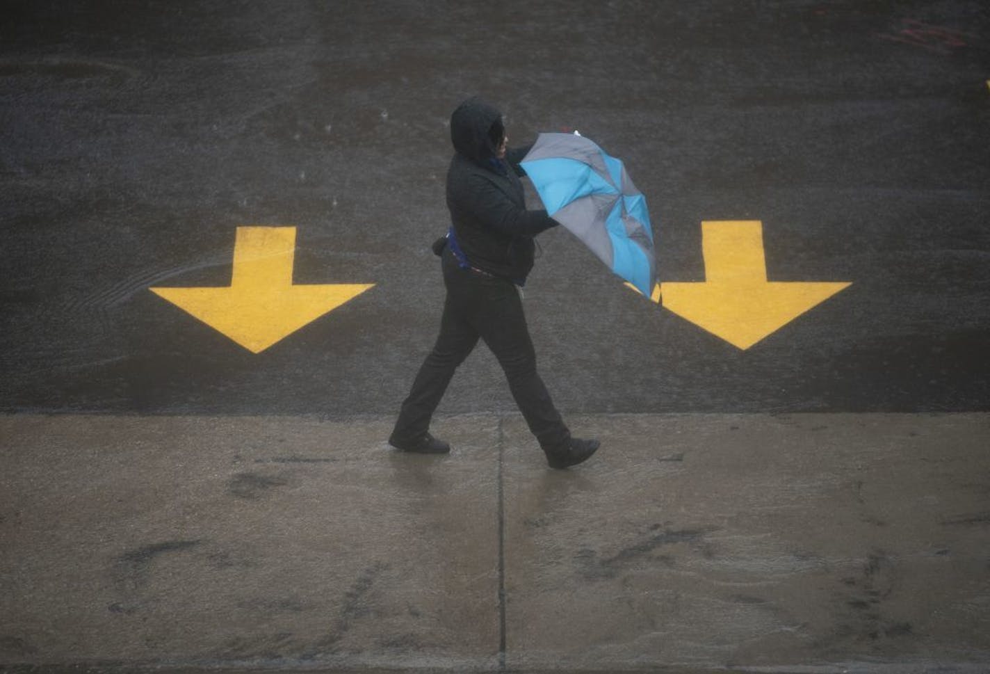 A woman adjusted her umbrella while walking along 3rd Ave. S. downtown Thursday afternoon.