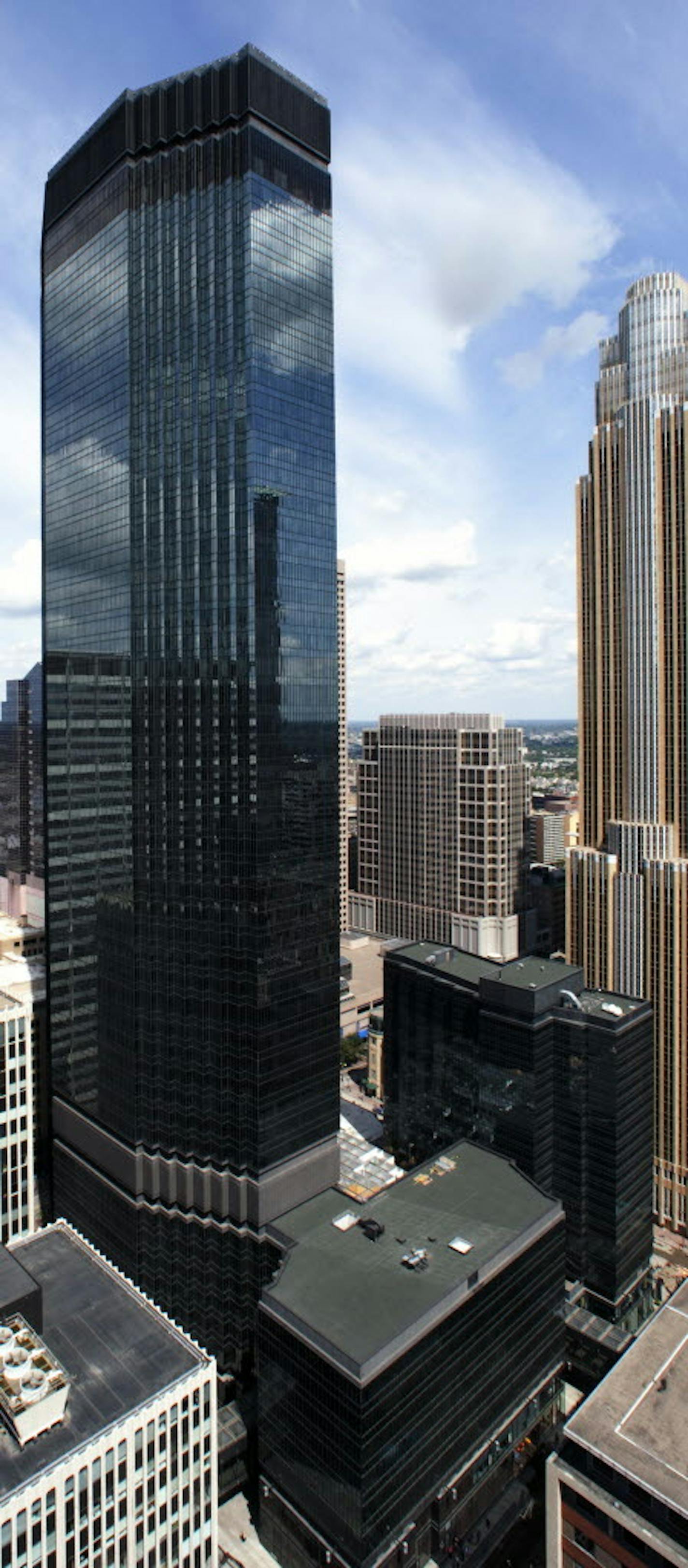 The IDS Center is in the foreground and the Marquette Hotel is the 12-story building in the background. The buildings have the same surface material.