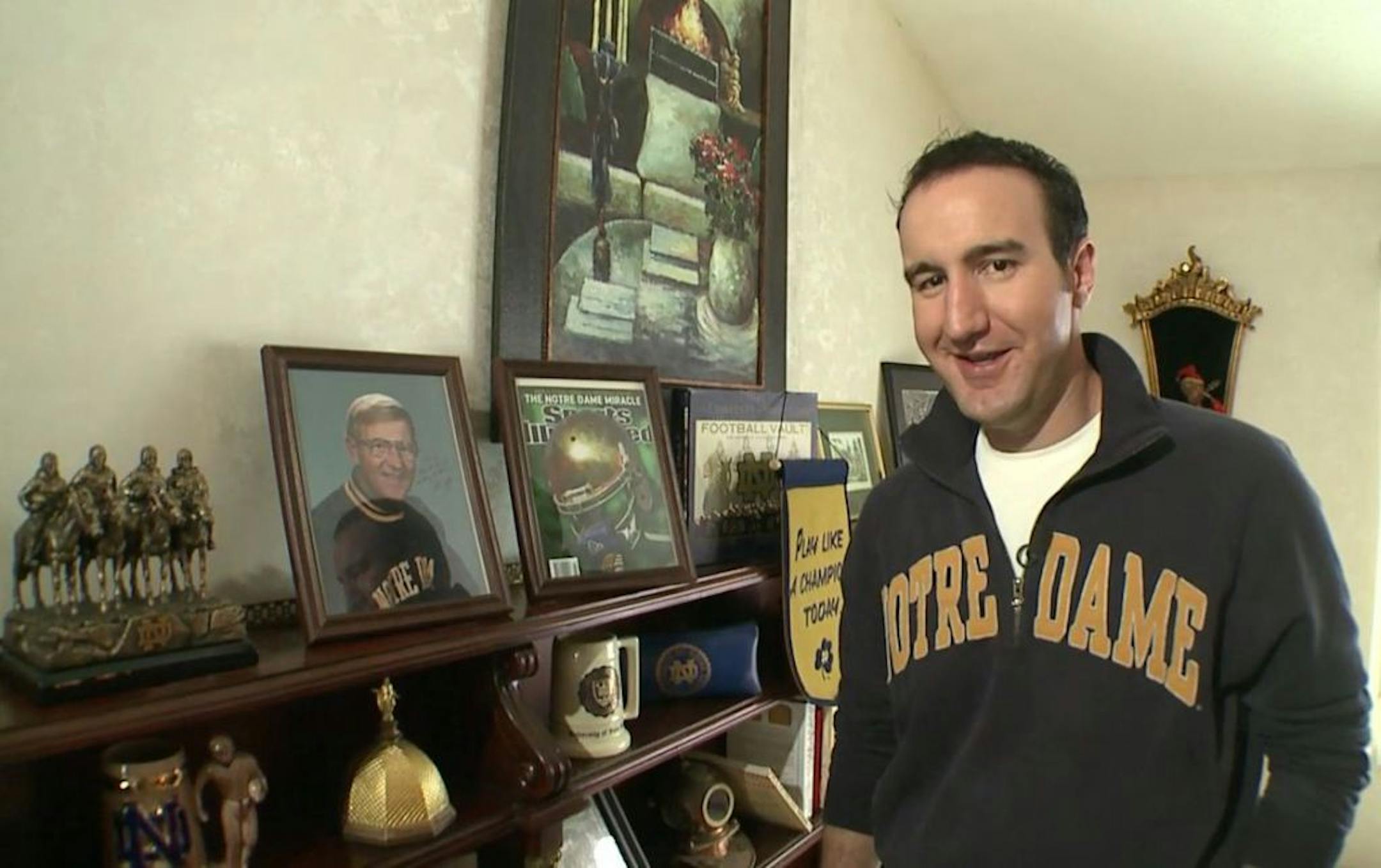 Dan Scaminace of Minnetonka, posing with a Notre Dame shrine.