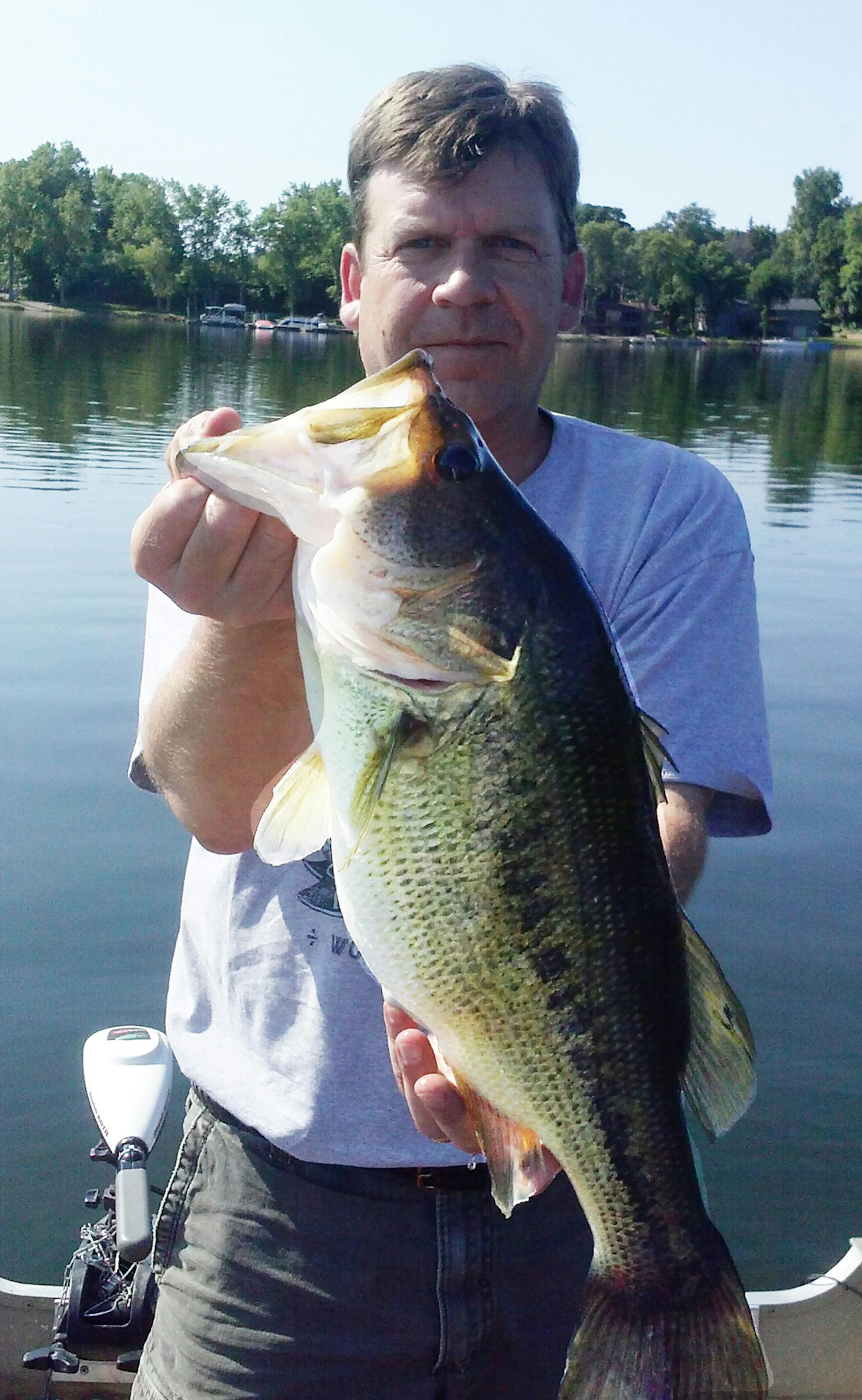 METRO LARGEMOUTH Kelly Labounty of Victoria caught this 22-inch-plus bass recently on a small west metro lake. ìThe fish hit on a Northland green weed weasel tipped with a minnow,íí said buddy Steve Frisch of Minnetonka, who netted the fish. ìWhen it came to the boat, I almost knocked it off the line, but I was able to get the net on it the second time around. The fish was released to be caught another day!íí