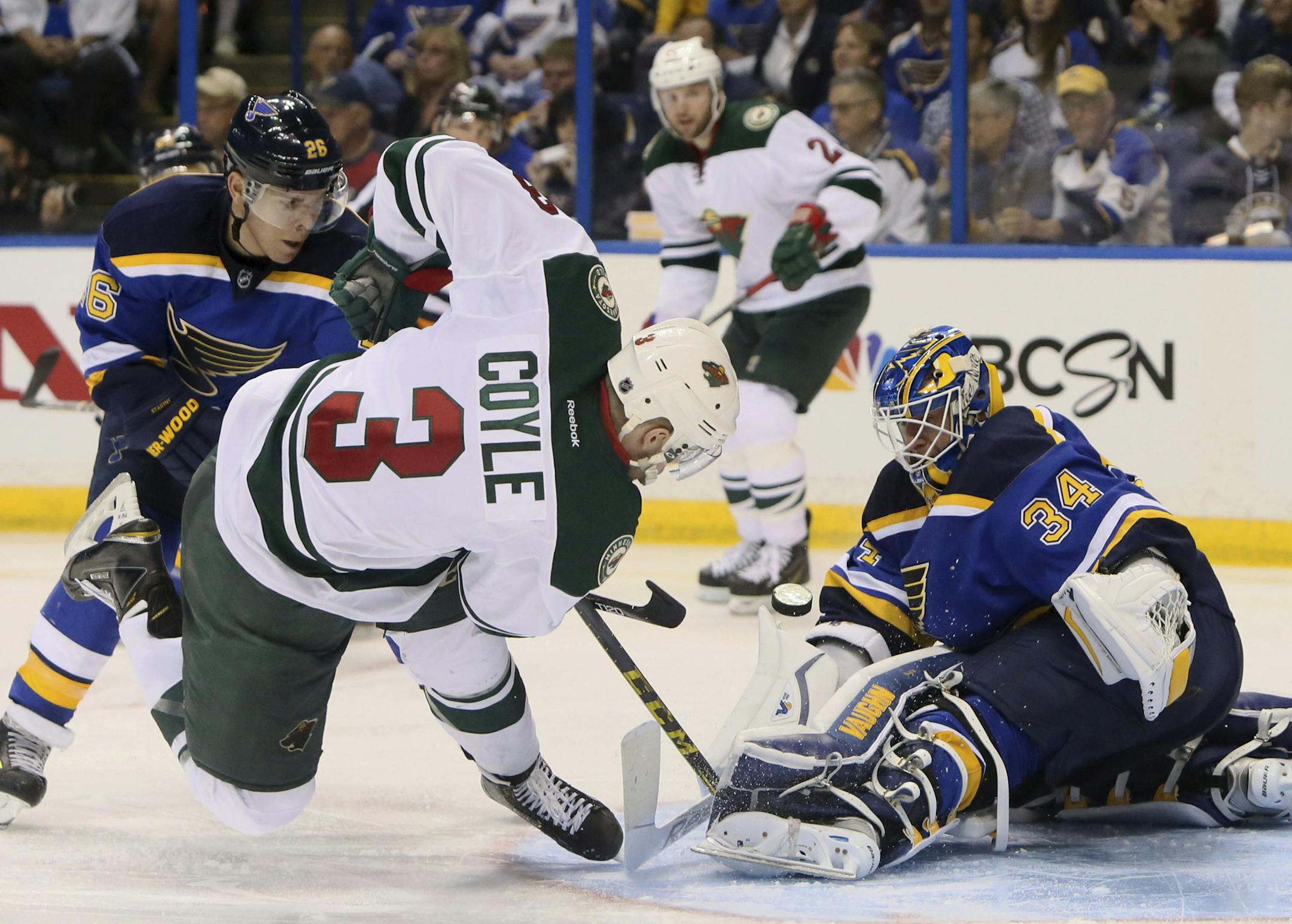 St. Louis Blues goaltender Jake Allen, right, prevents Minnesota Wild center Charlie Coyle from scoring, but Blues center Paul Stastny brings down Coyle, earning a penalty during the second period of Game 1 of an NHL hockey first-round playoff series, Thursday, April 16, 2015, in St. Louis. (Chris Lee/St. Louis Post-Dispatch via AP)