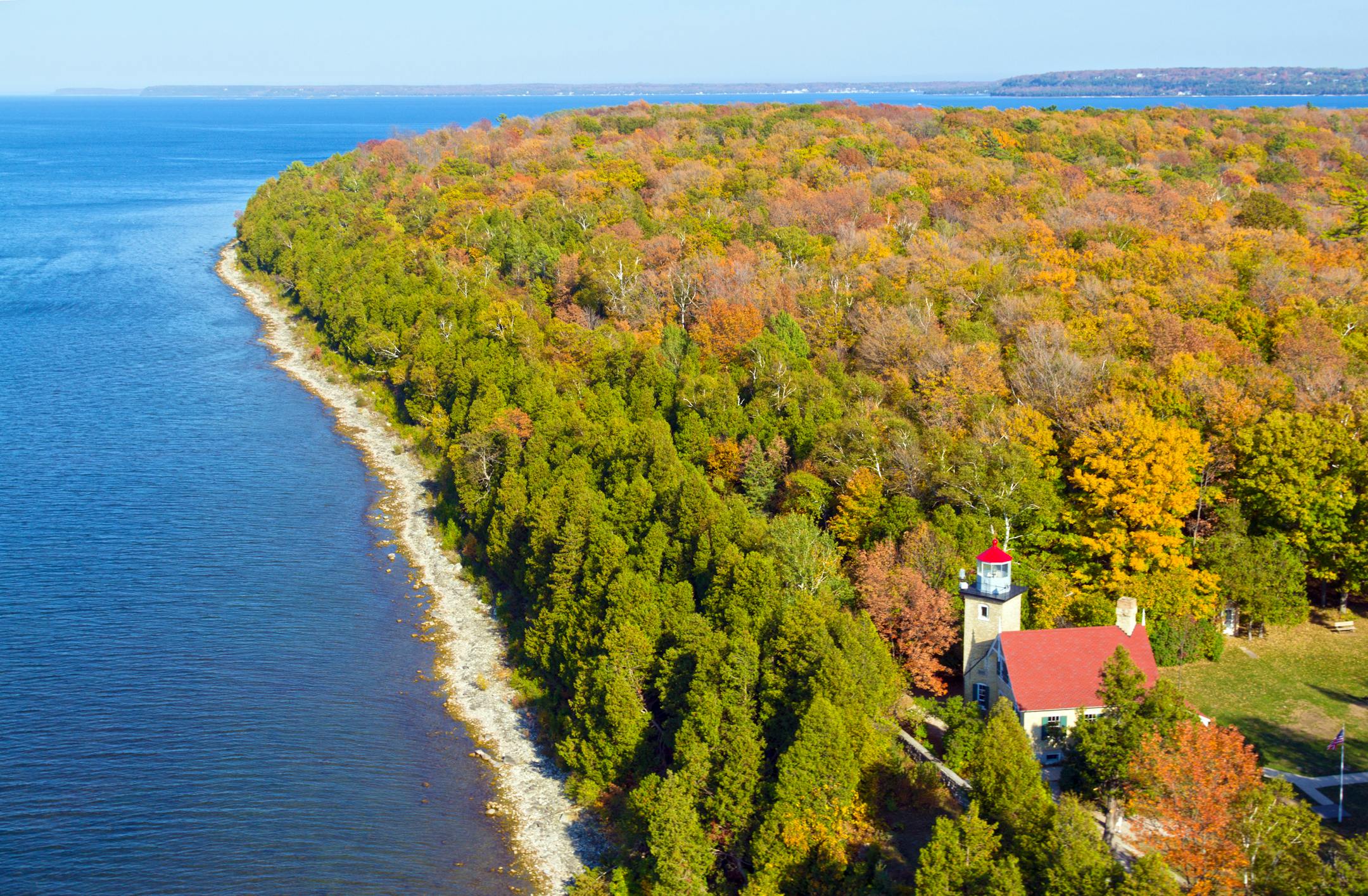 An aerial view of Eagle Bluff Lighthouse during the fall season in Peninsula State Park.
