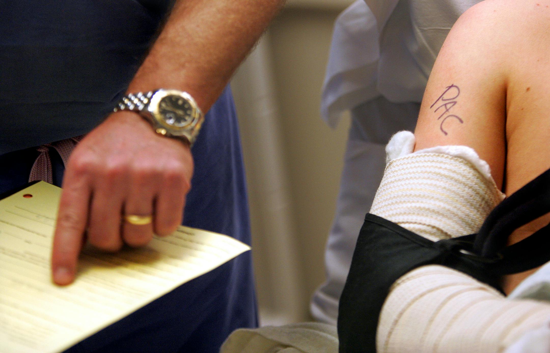 Doctor Peter Cole marked his initials his patients right arm before surgery at Regions Hospital in St. Paul Tuesday, January 6, 2009. The marking assures the surgery is done on the right area, and to help avoid mistakes during the process.