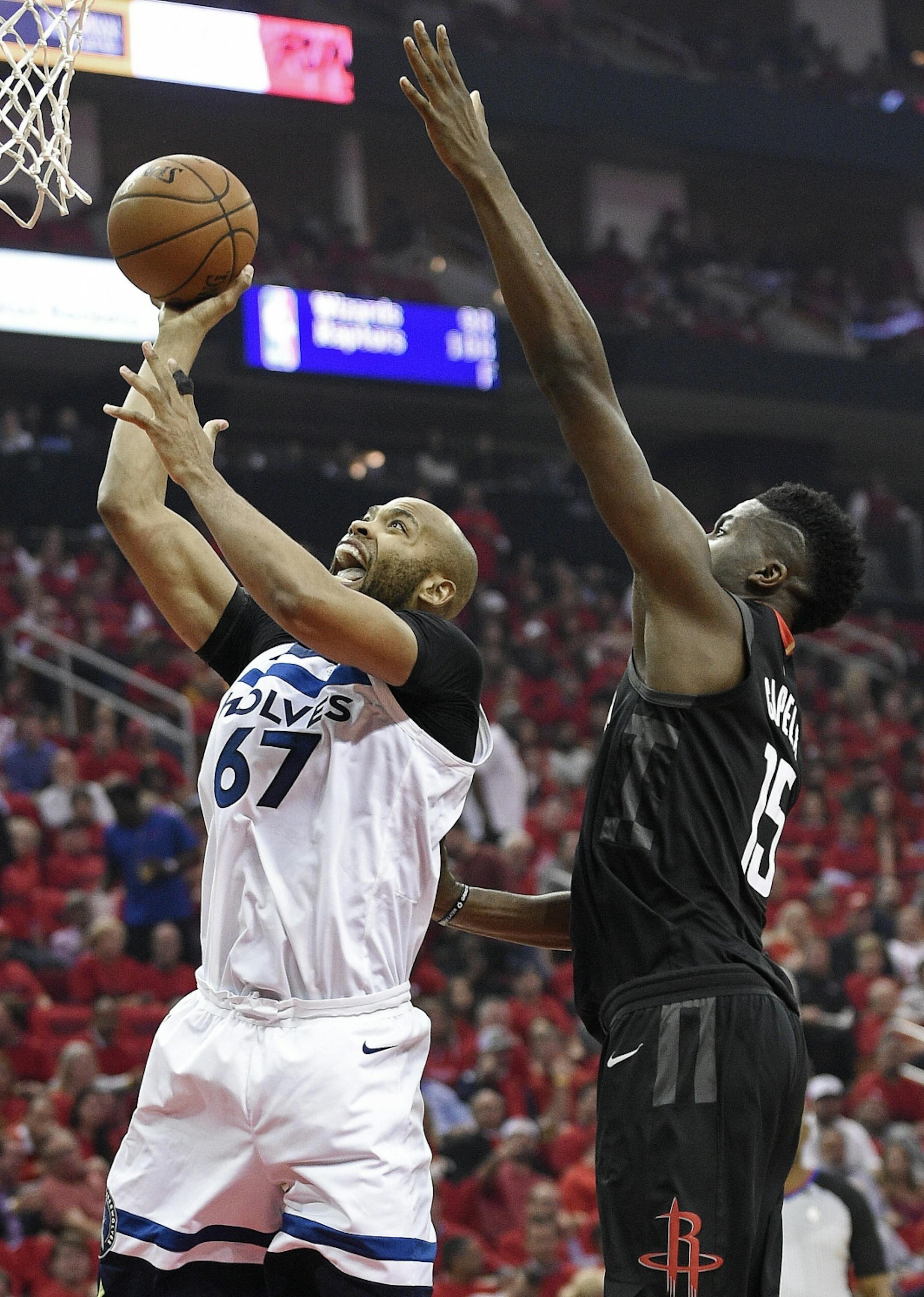 Minnesota Timberwolves forward Taj Gibson (67) shoots as Houston Rockets center Clint Capela defends during the first half in Game 5 of a first-round NBA basketball playoff series, Wednesday, April 25, 2018, in Houston.
