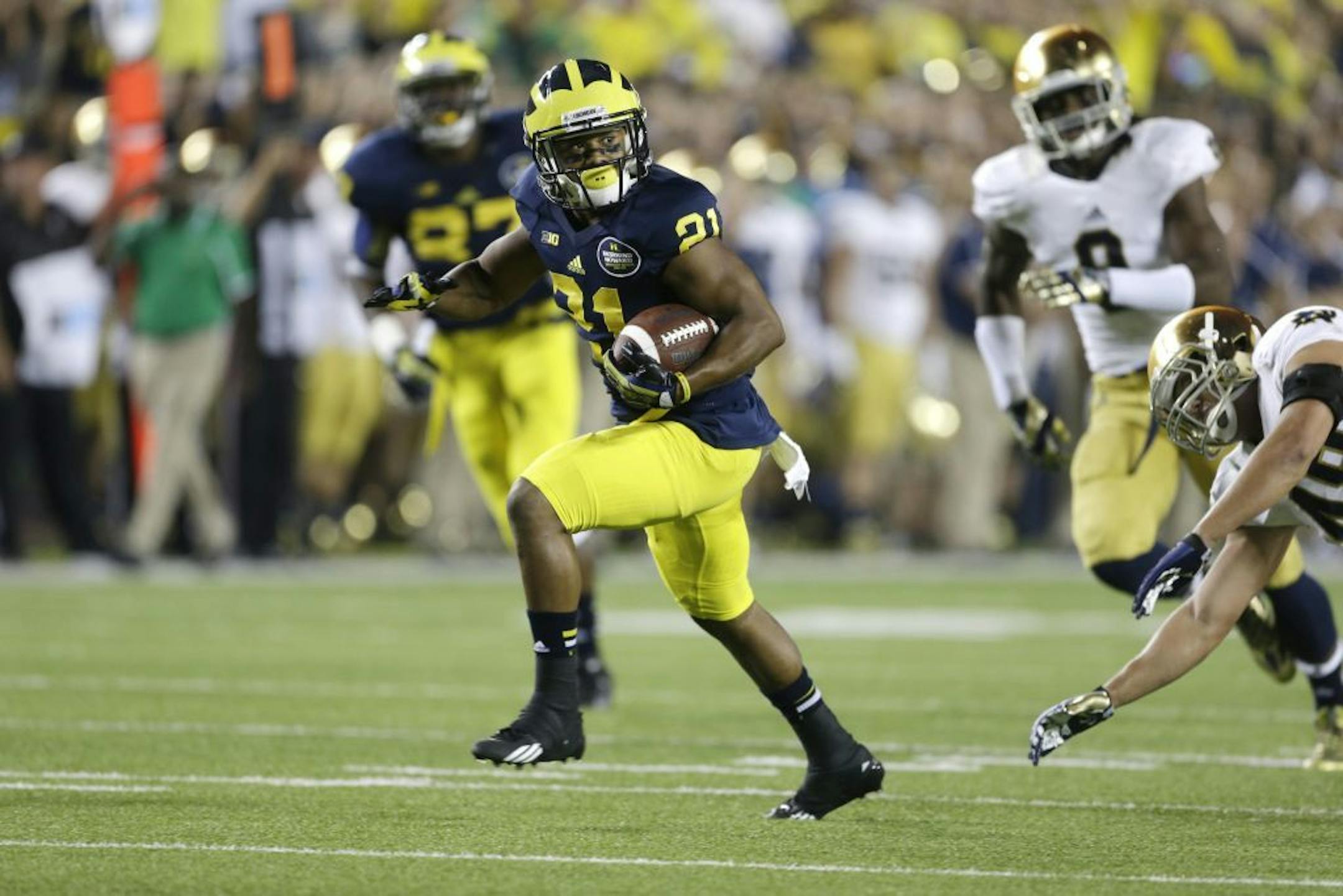 Michigan wide receiver Jeremy Gallon (21) pulls away from the Notre Dame defense for a touchdown during the first quarter of an NCAA college football game in Ann Arbor, Mich., Saturday, Sept. 7, 2013.