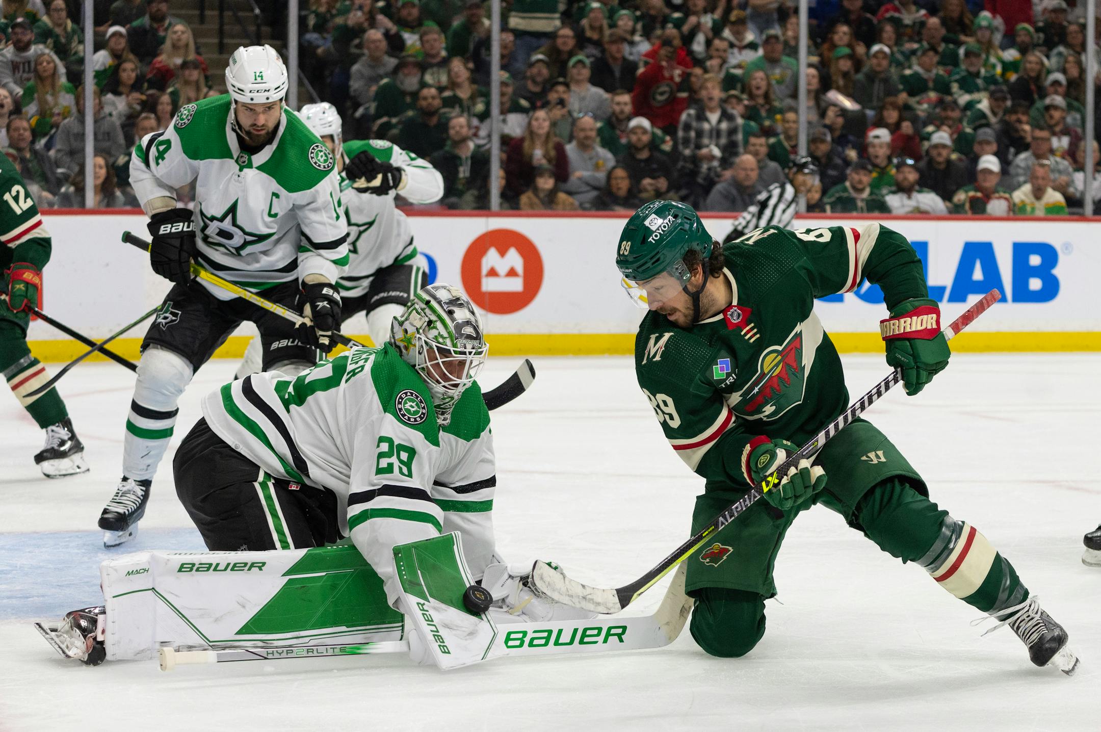 Minnesota Wild center Frederick Gaudreau (89) took a shot on Dallas Stars goaltender Jake Oettinger (29) from his knee in the second period. The Minnesota Wild faced the Dallas Stars in Game 6 of an NHL hockey Stanley Cup first-round playoff series Friday night at Xcel Energy Center in St. Paul.