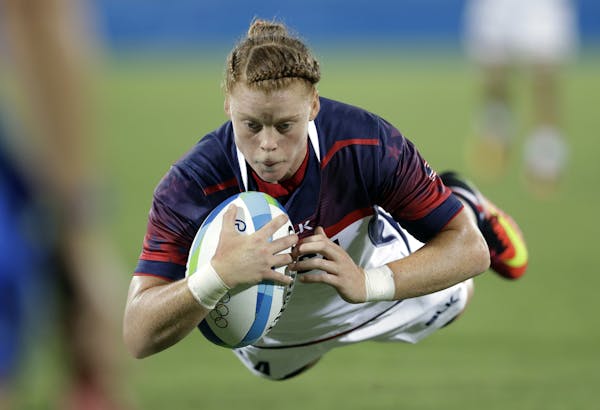 USA's Alev Kelter, scores a try during the women's rugby sevens match between USA and Colombia at the Summer Olympics in Rio de Janeiro, Brazil, Satur