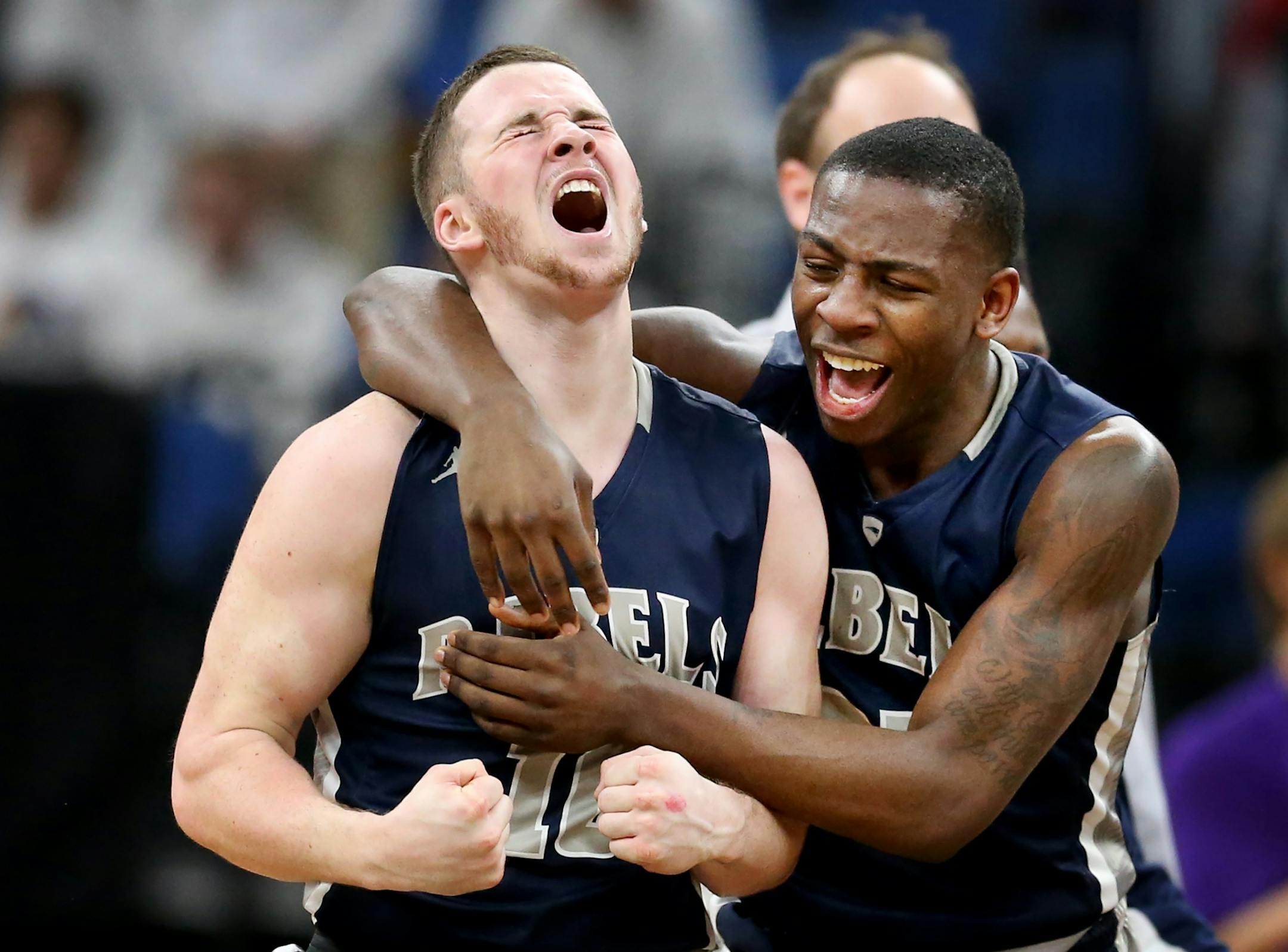 Sam Dubois left of Champlin celebrated his winning 3 point basket with teammate McKinley Wright during quarterfinal class 4A basketball action at Target Center Wednesday March 22 2017 in Minneapolis, MN.