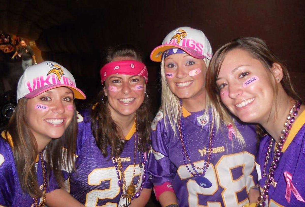 Holly Wruck, right, wore pink for breast cancer awareness at a Vikings game along with friends, from left, Darcy Schopf, Christie Carrera, Steph Lause