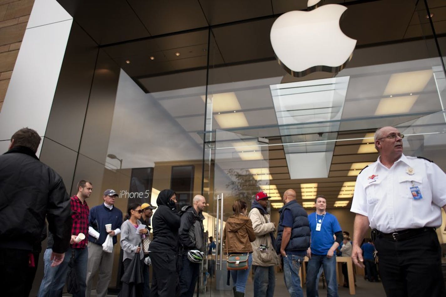 People stood in line Friday, September 21, 2012 at the Apple Store in Uptown, Minneapolis to buy the latest iPhone, version 5.