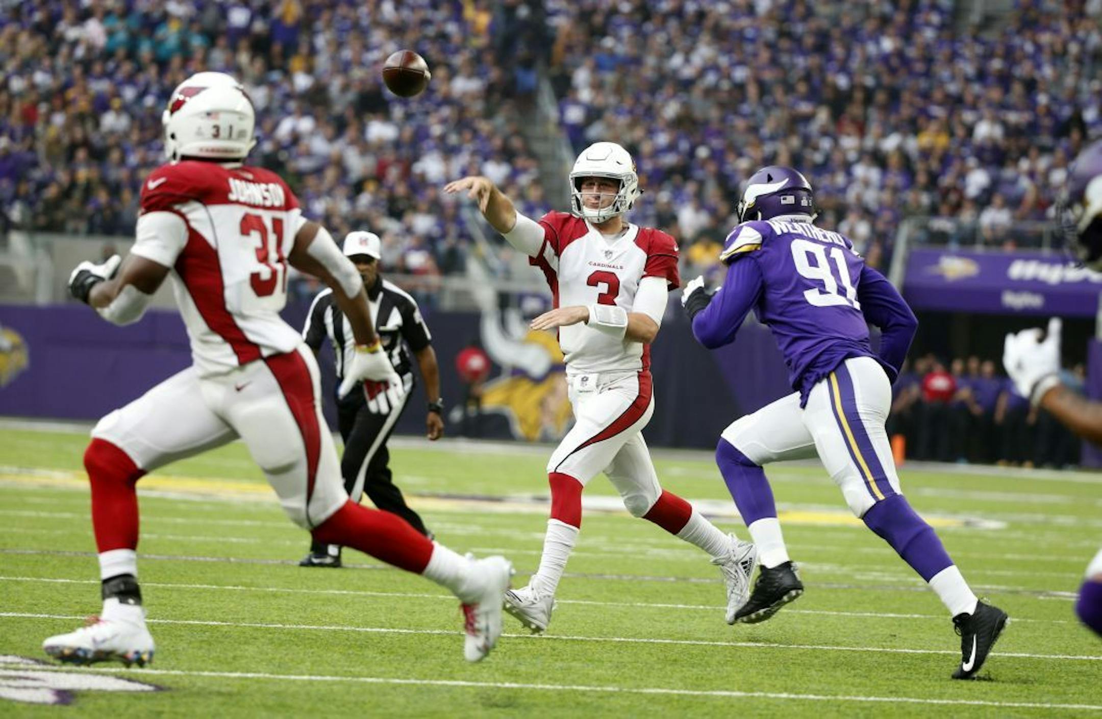 Arizona Cardinals quarterback Josh Rosen (3) throws a pass as he is pressured by Minnesota Vikings defensive end Stephen Weatherly (91) during the first half of an NFL football game, Sunday, Oct. 14, 2018, in Minneapolis.