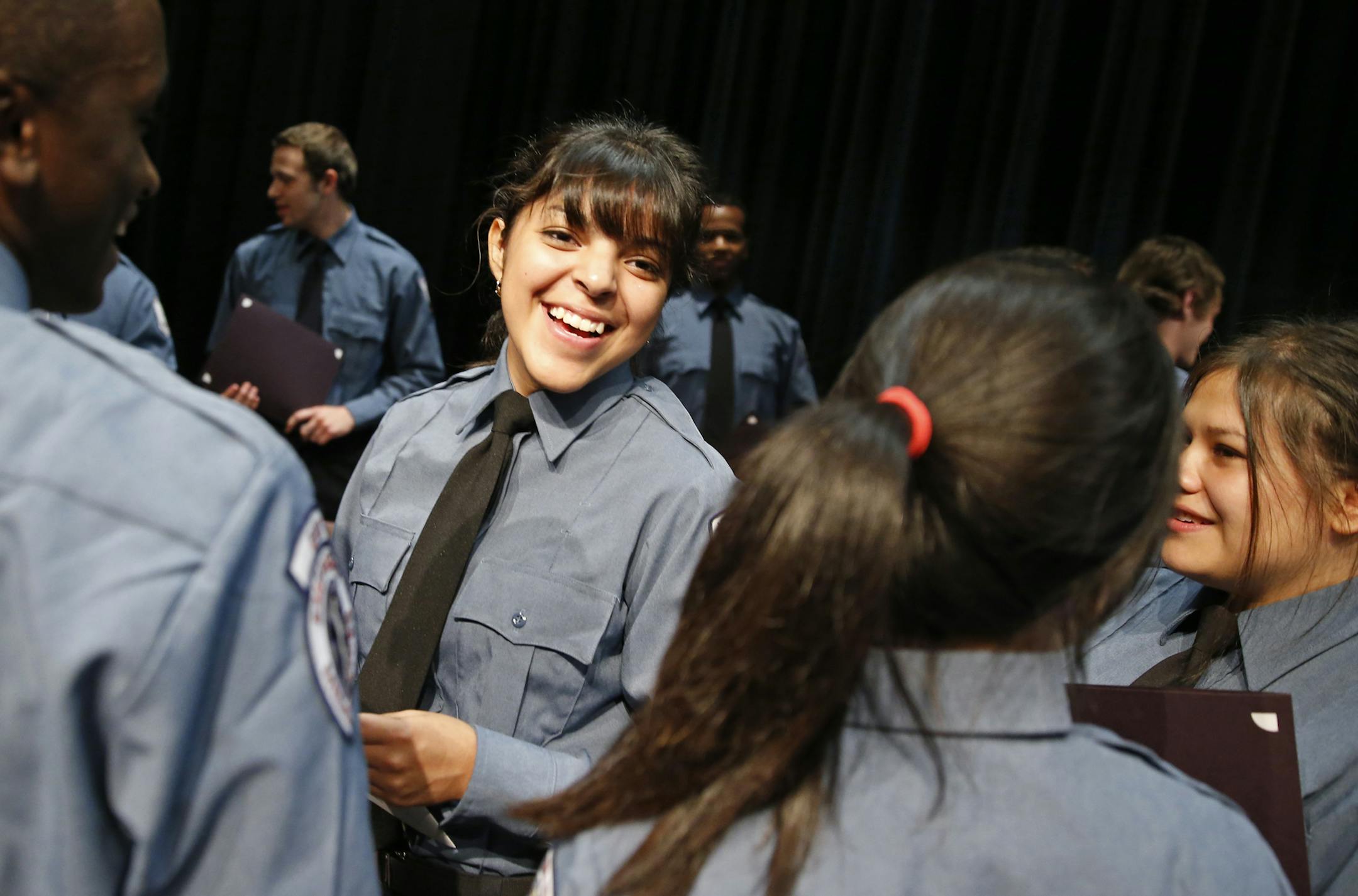 At the Wellstone Center in St. Paul, the Saint Paul EMS Academy graduated 17 EMT's including Alaina Carrion, second from left, who was also chosen as a keynote speaker .]tsong-taataarii@startribune.com