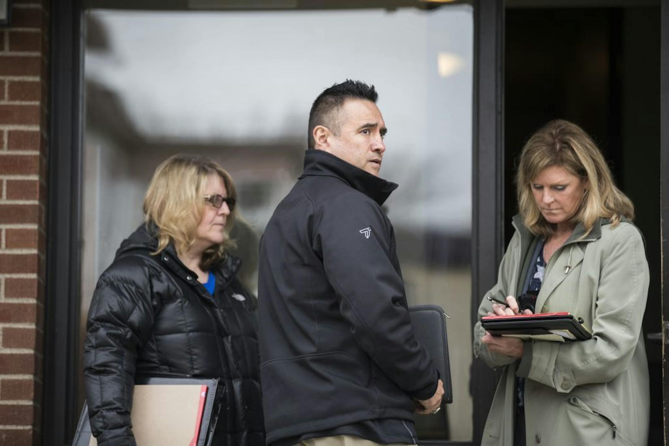Minneapolis Police homicide detectives Sgt. Twila Villella, from left, Sgt. Luis Porras, and Sgt. Ann Kjos investigate the scene of a homicide in Minneapolis.