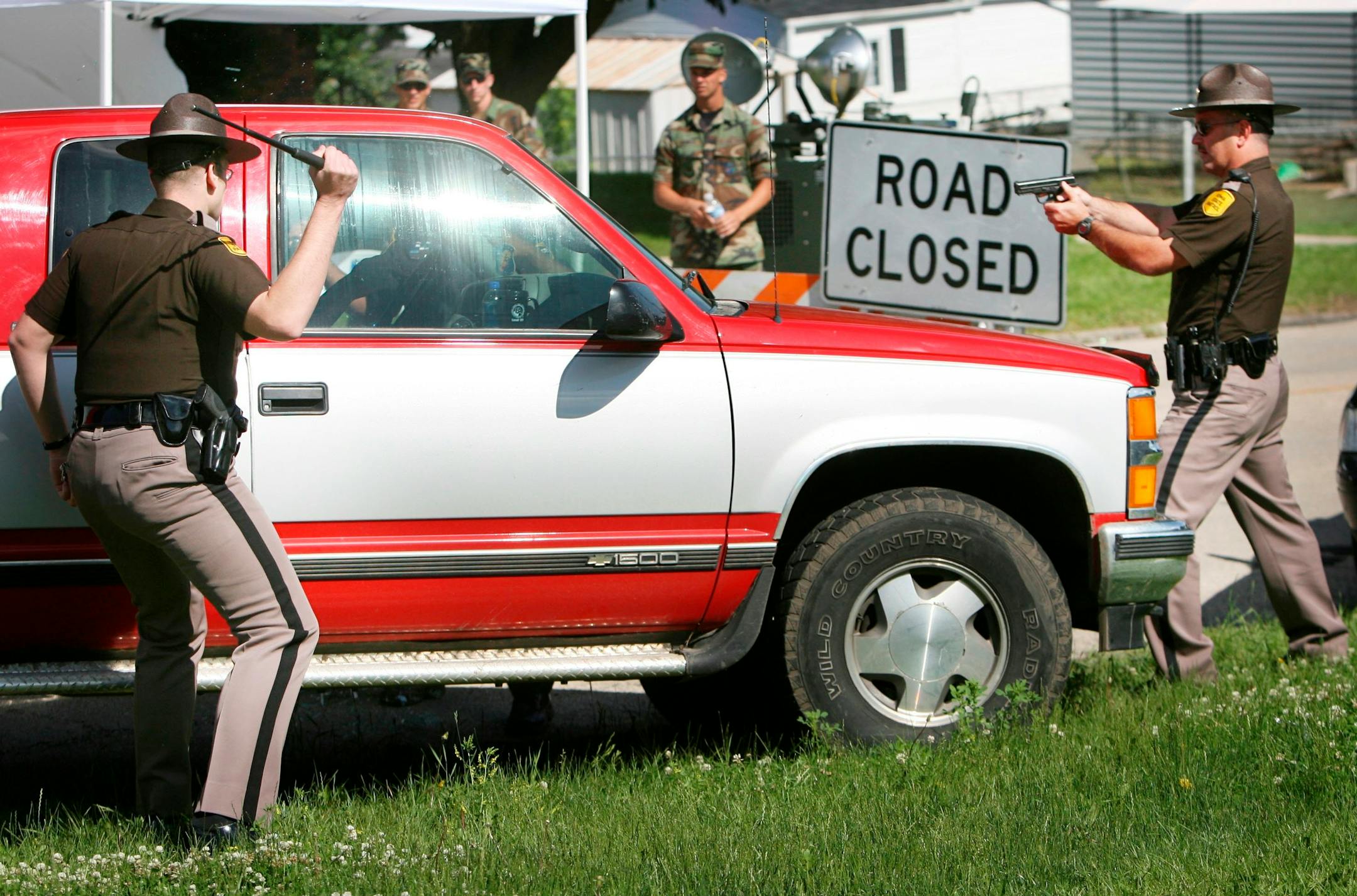 When an angry resident trying to run a security checkpoint in Cedar Rapids allegedly bumped an Iowa state trooper with his truck, troopers drew their guns.