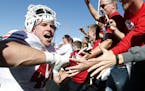 Wisconsin linebacker T.J. Watt, left, celebrates with fans after an NCAA college football game against Iowa, Saturday, Oct. 22, 2016, in Iowa City, Io