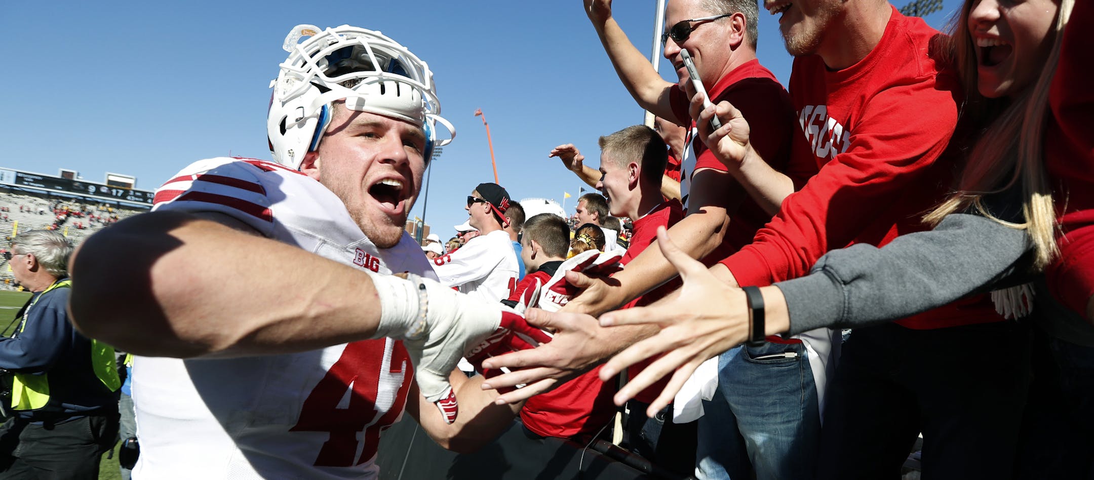 Wisconsin linebacker T.J. Watt, left, celebrates with fans after an NCAA college football game against Iowa, Saturday, Oct. 22, 2016, in Iowa City, Iowa. Wisconsin won 17-9. (AP Photo/Charlie Neibergall)