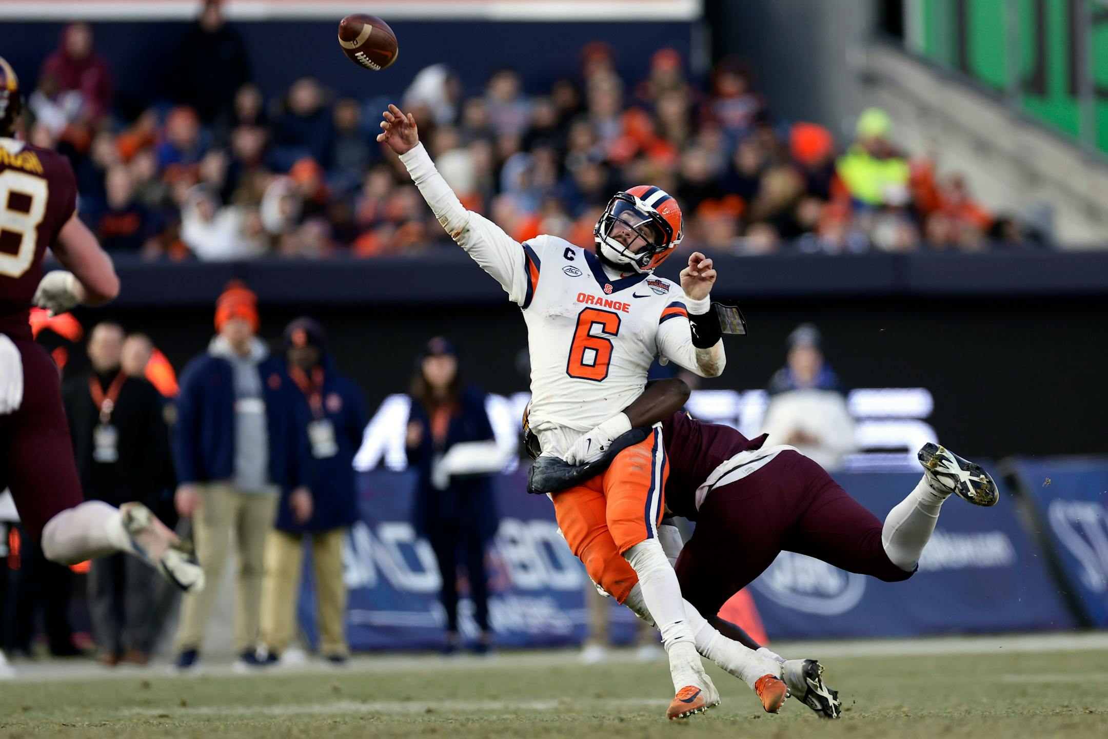 Syracuse quarterback Garrett Shrader (6) throws while being tackled by Minnesota defensive lineman Jah Joyner during the second half.