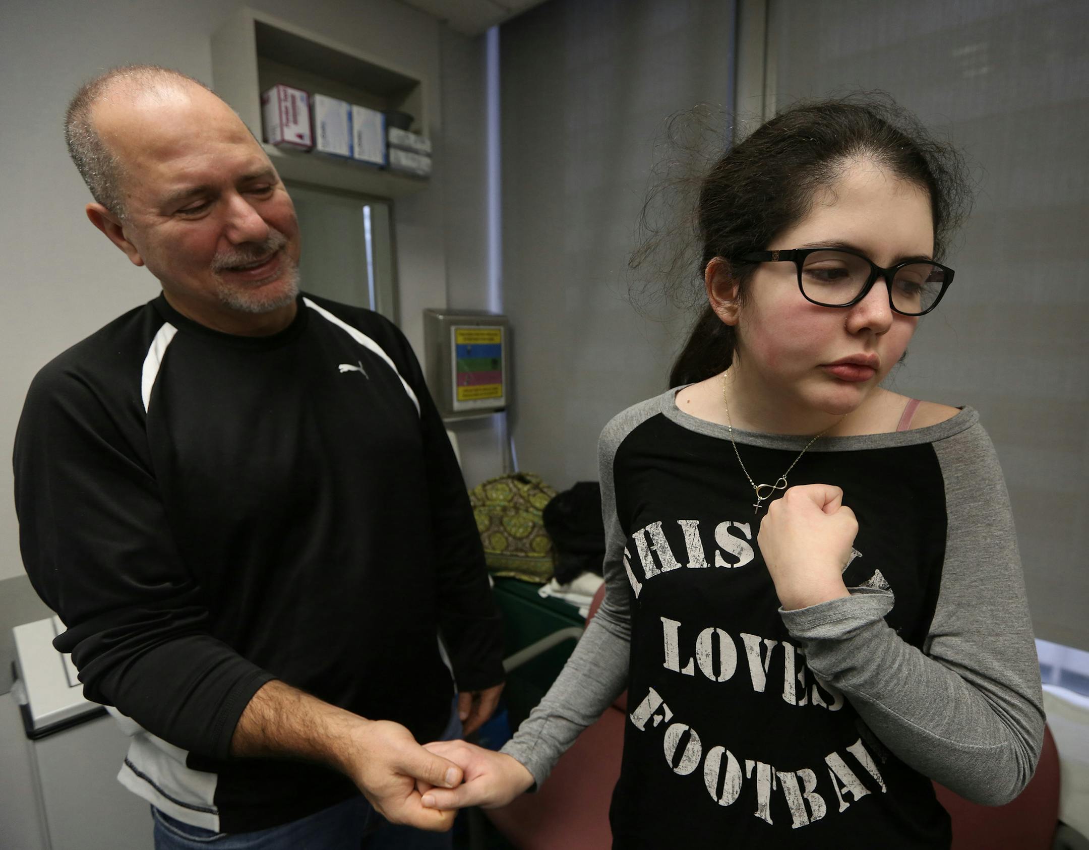 Harry Koujaian and his daughter Hayley wait for Dr. Elizabeth Berry-Kravis to come into the room to see Haley on Feb. 3, 2016 at RUsh University Medical Center in Chicago. Hayley, 16, has Niemann-Pick Type C (NP-C) disease and is going through a series of treatments with an experimental drug at Rush. (Nancy Stone/Chicago Tribune/TNS)