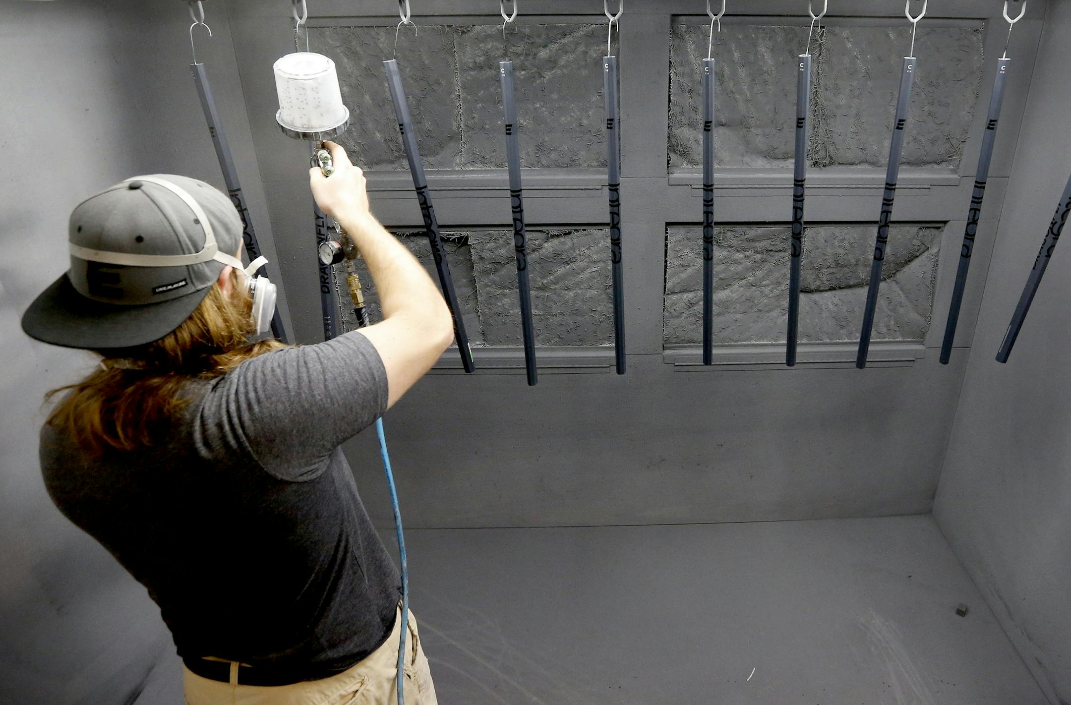 Luke Stein applied a clear coat lacrosse sticks at Epoch Lacrosse in Roseville. ] CARLOS GONZALEZ cgonzalez@startribune.com - May 24, 2016, Roseville, MN, Epoch Lacrosse, Roseville-based Epoch Lacrosse moved into 10,000 sf of new space last fall. Now they've launched C6 Composites to design, engineer and produce carbon fiber lacrosse equipment.