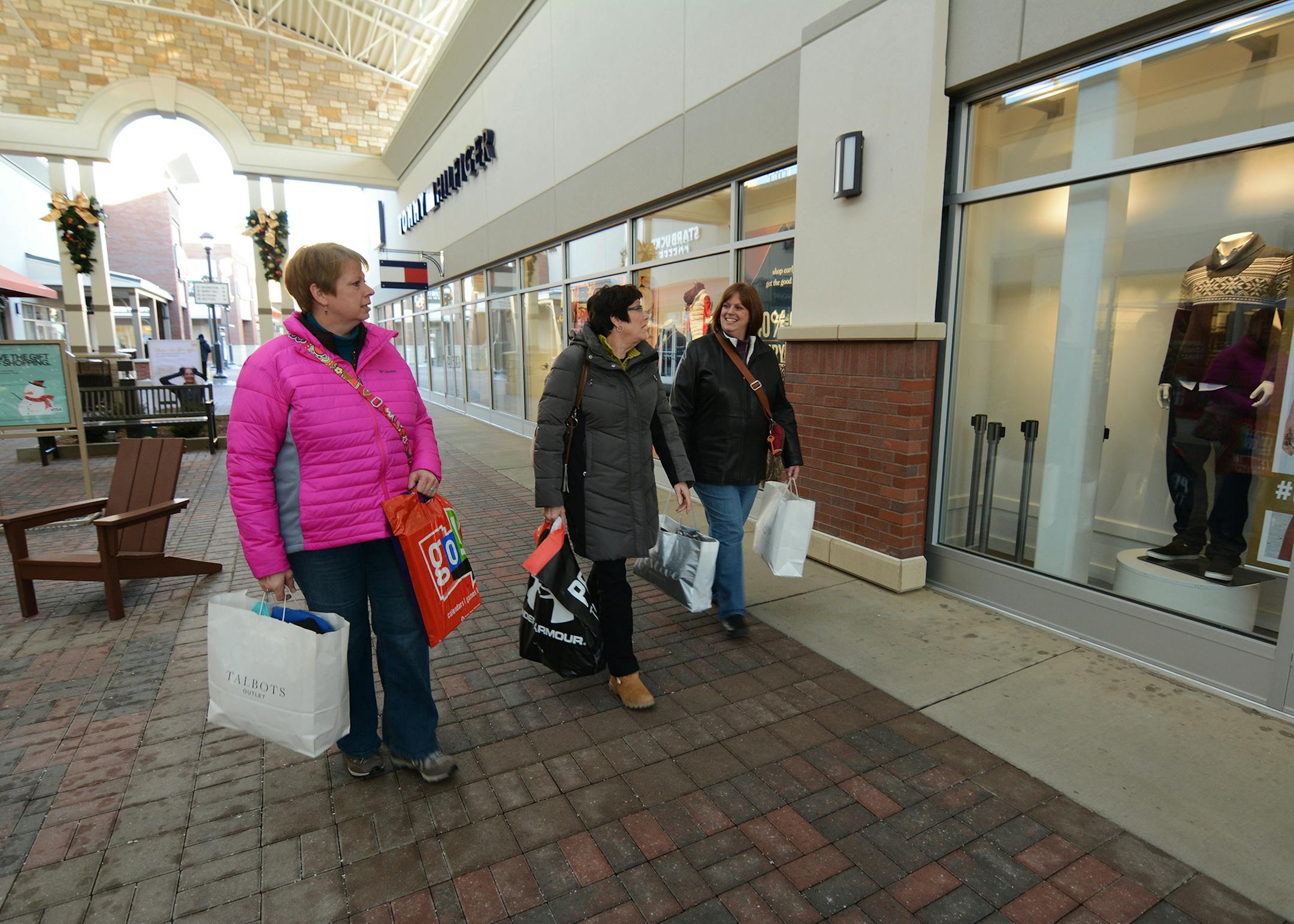 Denise Peterson (pink), Pam Foesch (green), Brenda Peterson (purple) of Hector, Minn. shopped at Twin Cities Premium Outlets, the new outlet mall in Eagan. Photo by Liz Rolfsmeier, Special to the Star Tribune