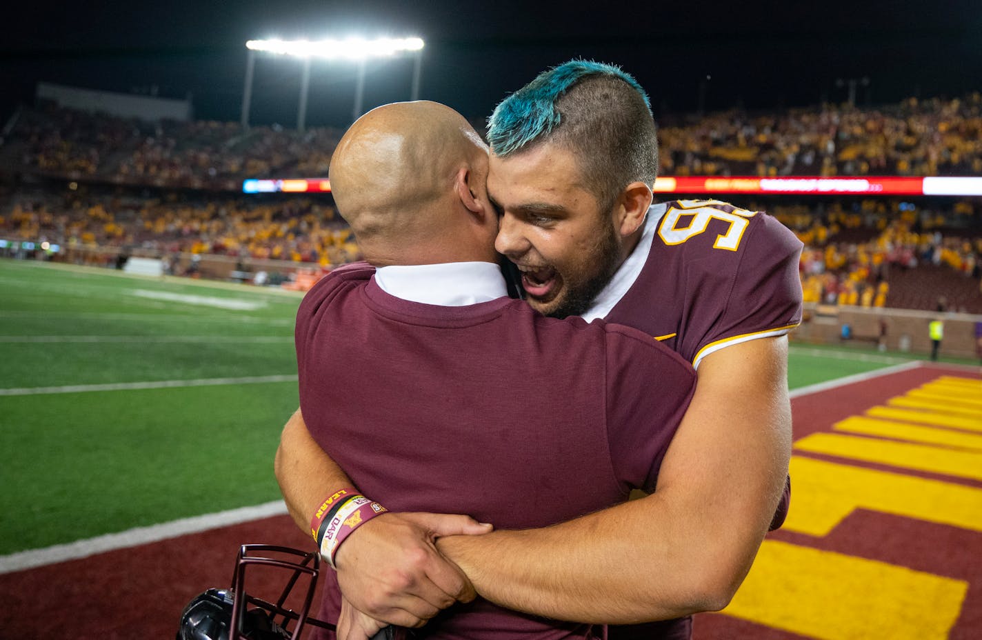 Minnesota Gophers head coach P.J. Fleck embraces place kicker Dragan Kesich (99) after hitting a 47-yard game winning field goal as time expired to beat Nebraska 13-10 Thursday, Aug. 31, 2023, at Huntington Bank Stadium in Minneapolis, Minn. ]