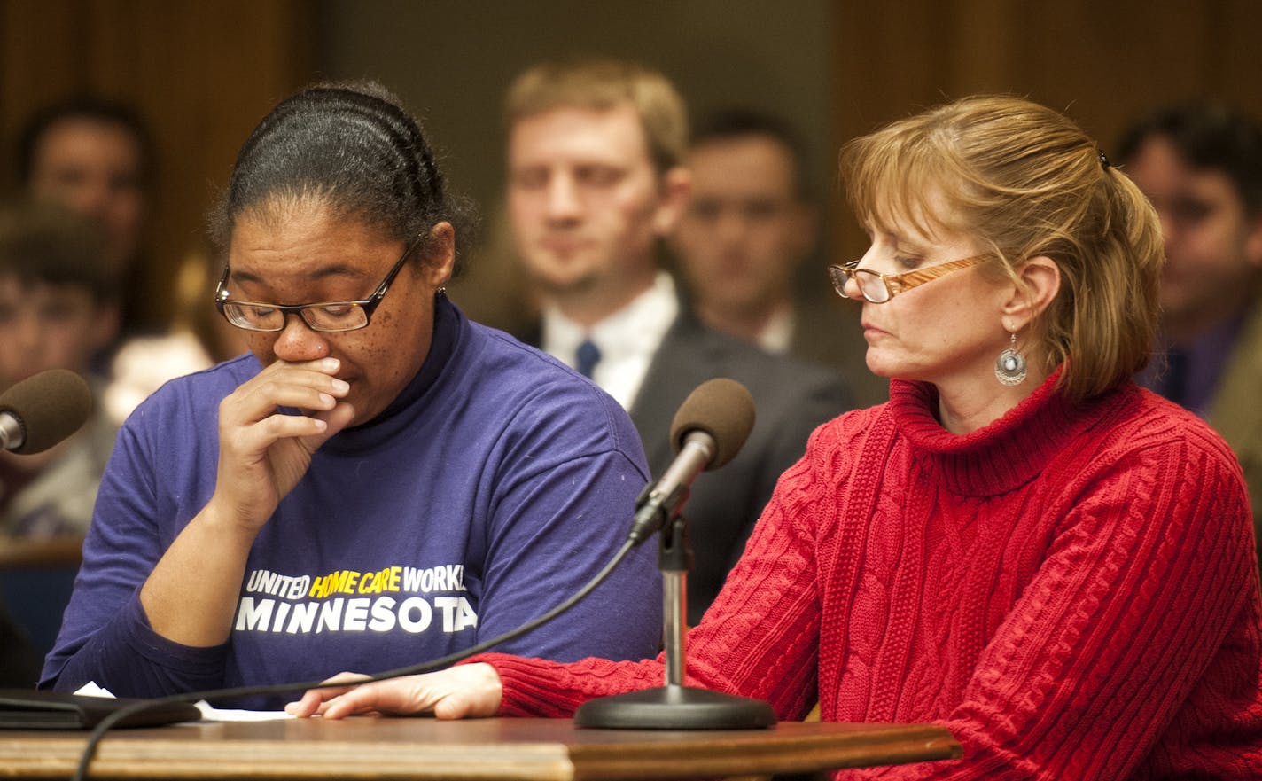 Shaquonica Johnson was comforted by fellow home-care worker Rochelle Turan while testifying at a March hearingat the State Capitol on the possible unionization of home-based care providers.