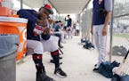 Minnesota Twins third baseman Miguel Sano (22) hung out in the dugout at the practice field as he sat out another day of workouts wearing a boot on hi