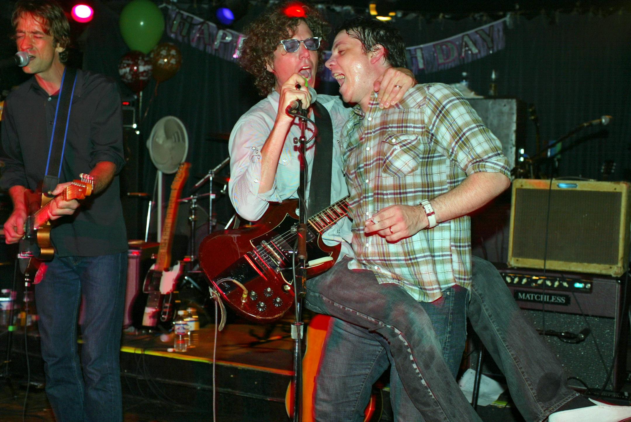 Jun 7, 2003: Gary Louris got carried away, literally, by Jeff Tweedy as they sang backing vocals while Jim Boquist, left, sang lead on a Golden Smog number at the 400 Bar in Minneapolis.