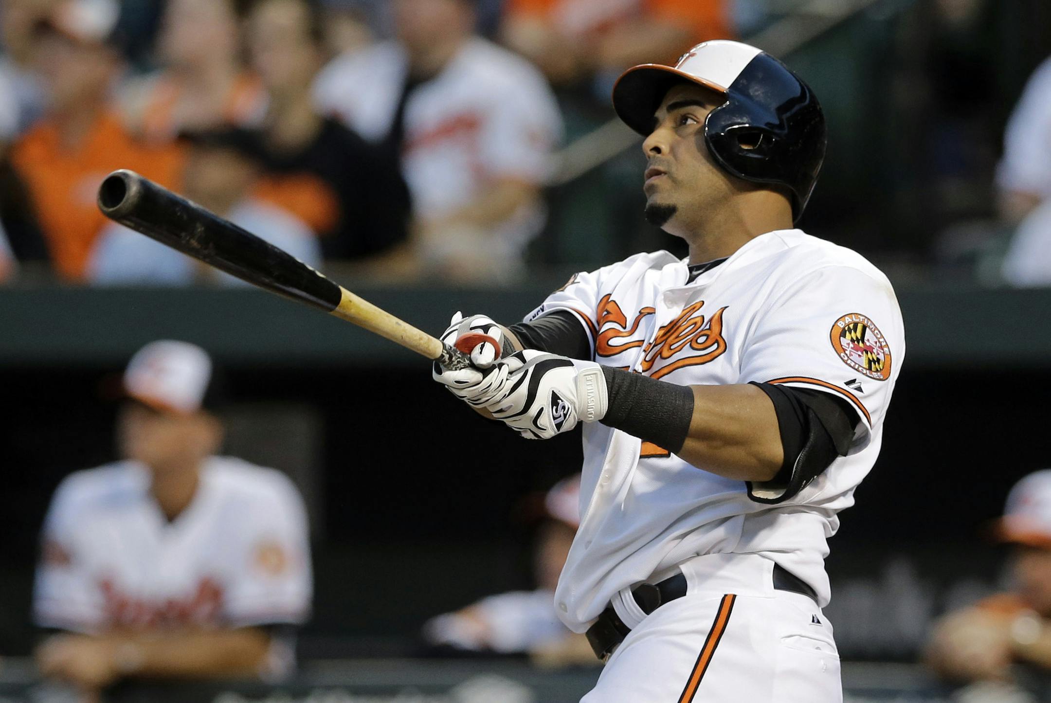 Baltimore Orioles' Nelson Cruz watches his two-run home run in the first inning of an interleague baseball game against the Cincinnati Reds, Thursday, Sept. 4, 2014, in Baltimore. (AP Photo/Patrick Semansky)