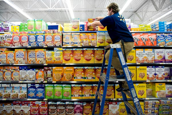 Wes Stevenson climbed a ladder to perfect the cereal display in Fayetteville, Ark., Oct. 12, 2016.
